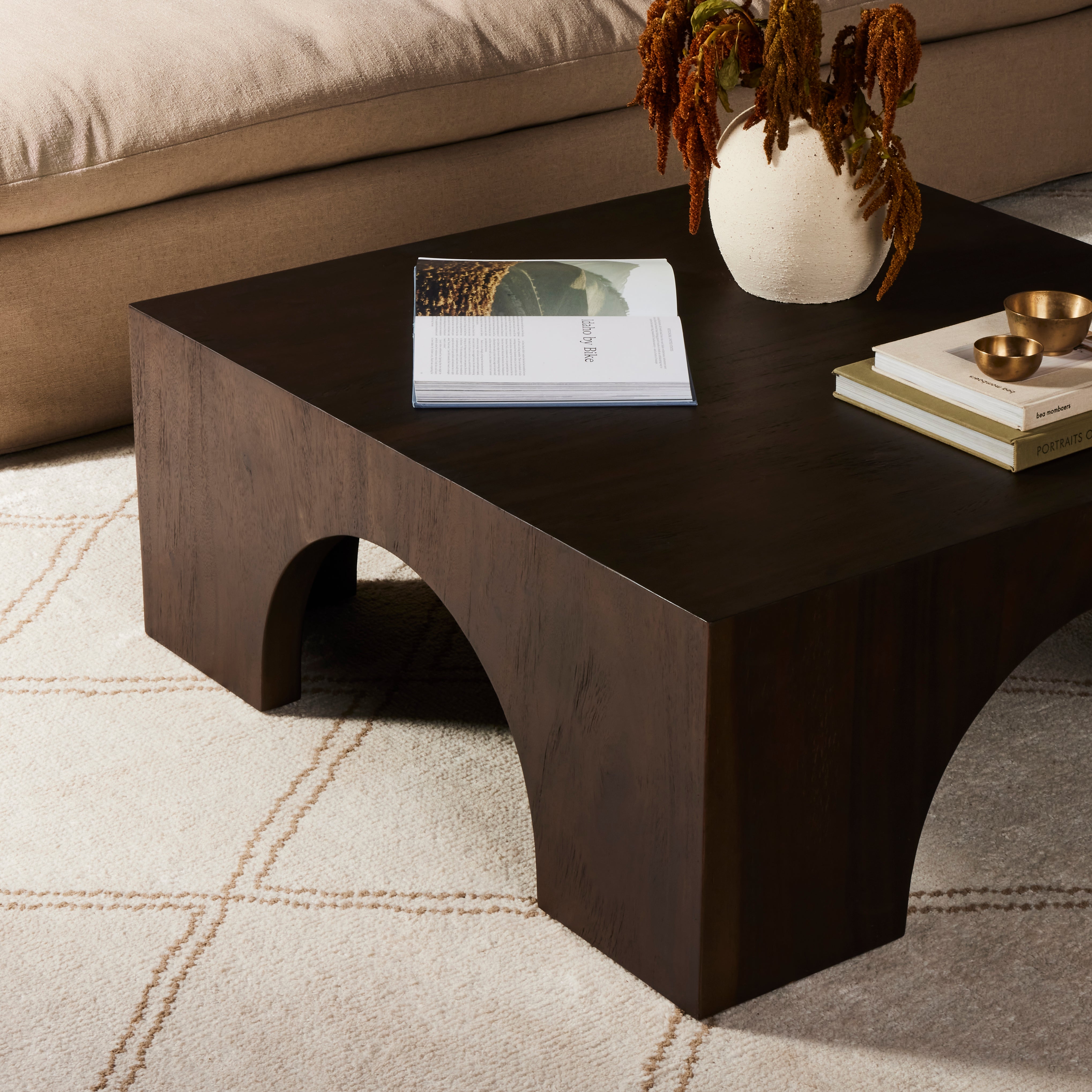 Clean and simple, with great impact. Made from beautiful Guanacaste in a natural hue, shapely arches and block corners speak to the architectural inspiration behind this eye-catching coffee table. Amethyst Home provides interior design, new construction, custom furniture, and area rugs in the Laguna Beach metro area.
