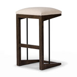 Featuring Finn Sienna Brown Oak Bar Stool by Four Hands at Amethyst Home. A stunner from every angle, this architecturally inspired stool features an angular base crafted from solid oak with two iron rods for added support and visual interest. Seat is upholstered in a linen/cotton/poly blend performance fabric with subtle texture throughout. Performance fab. Amethyst Home provides interior design, new home construction design consulting, vintage area rugs, and lighting in the Calabasas metro area.