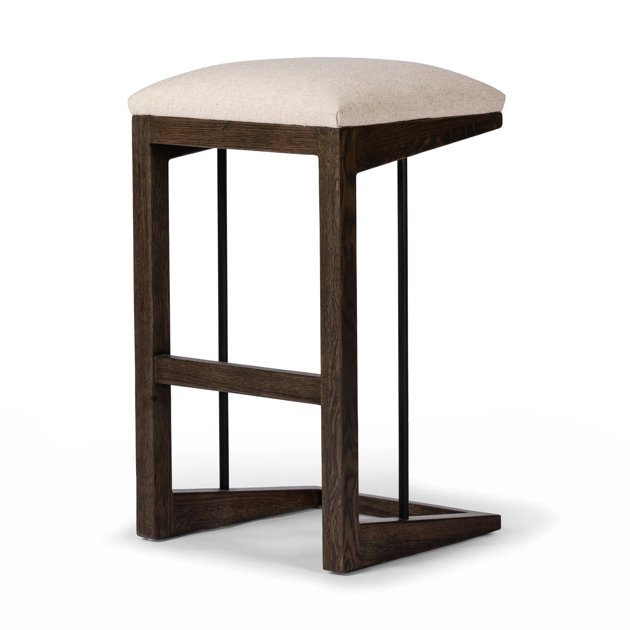 A stunner from every angle, this architecturally inspired stool features an angular base crafted from solid oak with two iron rods for added support and visual interest. Seat is upholstered in a linen/cotton/poly blend performance fabric with subtle texture throughout. Amethyst Home provides interior design, new home construction design consulting, vintage area rugs, and lighting in the Calabasas metro area.