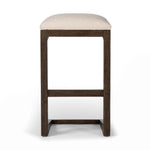 Featuring Finn Sienna Brown Oak Bar Stool by Four Hands at Amethyst Home. A stunner from every angle, this architecturally inspired stool features an angular base crafted from solid oak with two iron rods for added support and visual interest. Seat is upholstered in a linen/cotton/poly blend performance fabric with subtle texture throughout. Performance fab. Amethyst Home provides interior design, new home construction design consulting, vintage area rugs, and lighting in the Park City metro area.