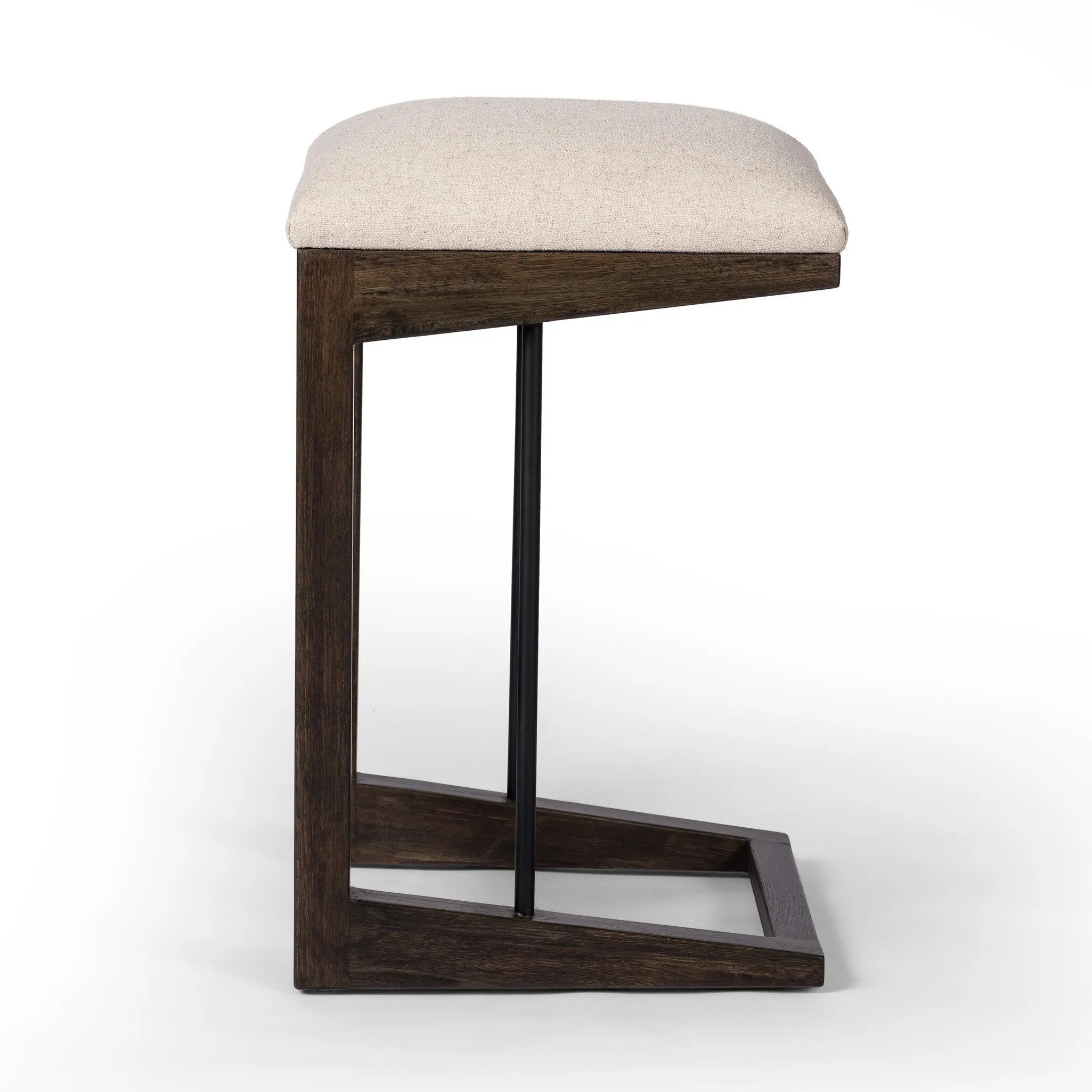 A stunner from every angle, this architecturally inspired stool features an angular base crafted from solid oak with two iron rods for added support and visual interest. Seat is upholstered in a linen/cotton/poly blend performance fabric with subtle texture throughout. Amethyst Home provides interior design, new home construction design consulting, vintage area rugs, and lighting in the Park City metro area.