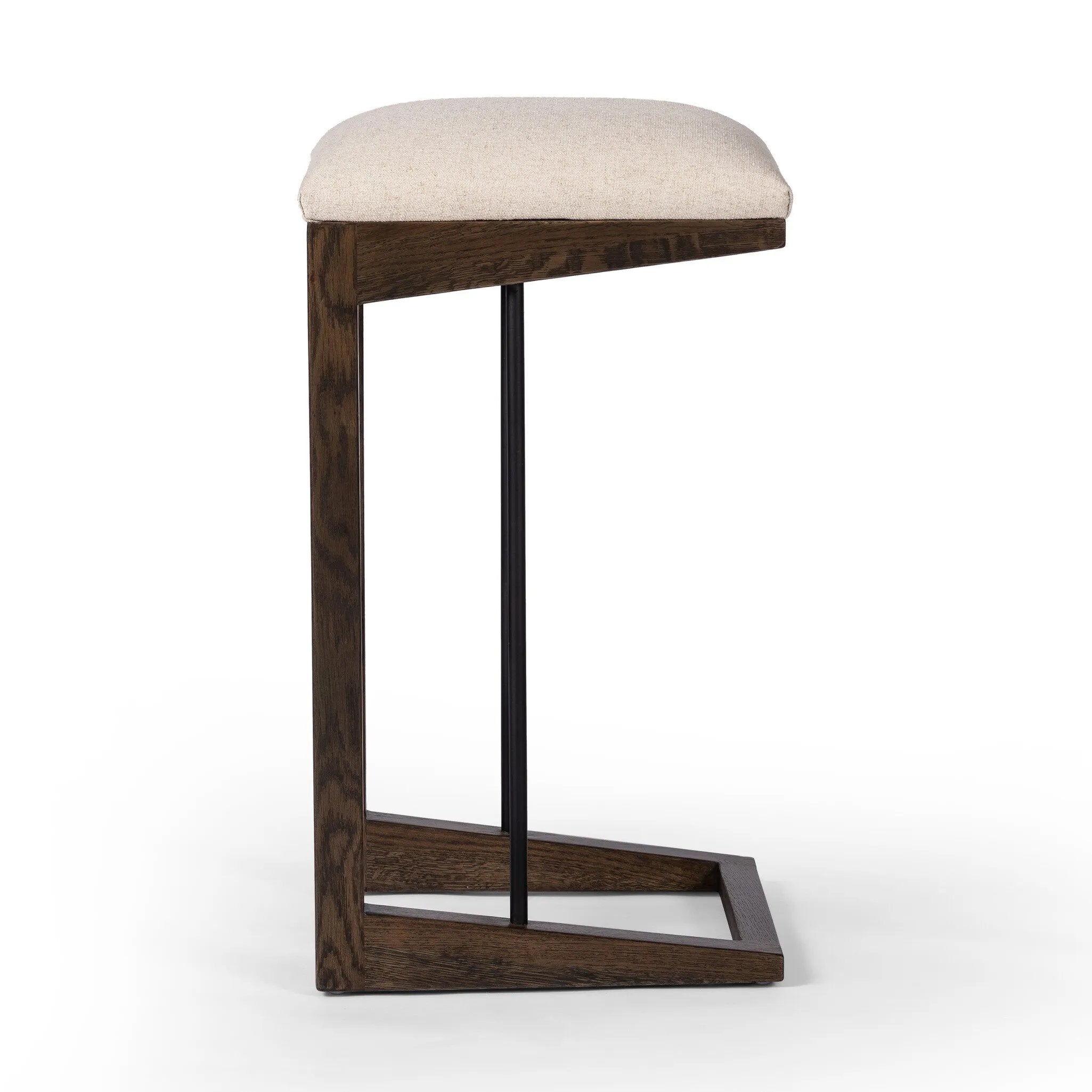 Featuring Finn Sienna Brown Oak Bar Stool by Four Hands at Amethyst Home. A stunner from every angle, this architecturally inspired stool features an angular base crafted from solid oak with two iron rods for added support and visual interest. Seat is upholstered in a linen/cotton/poly blend performance fabric with subtle texture throughout. Performanc. Amethyst Home provides interior design, new home construction design consulting, vintage area rugs, and lighting in the Salt Lake City metro area.