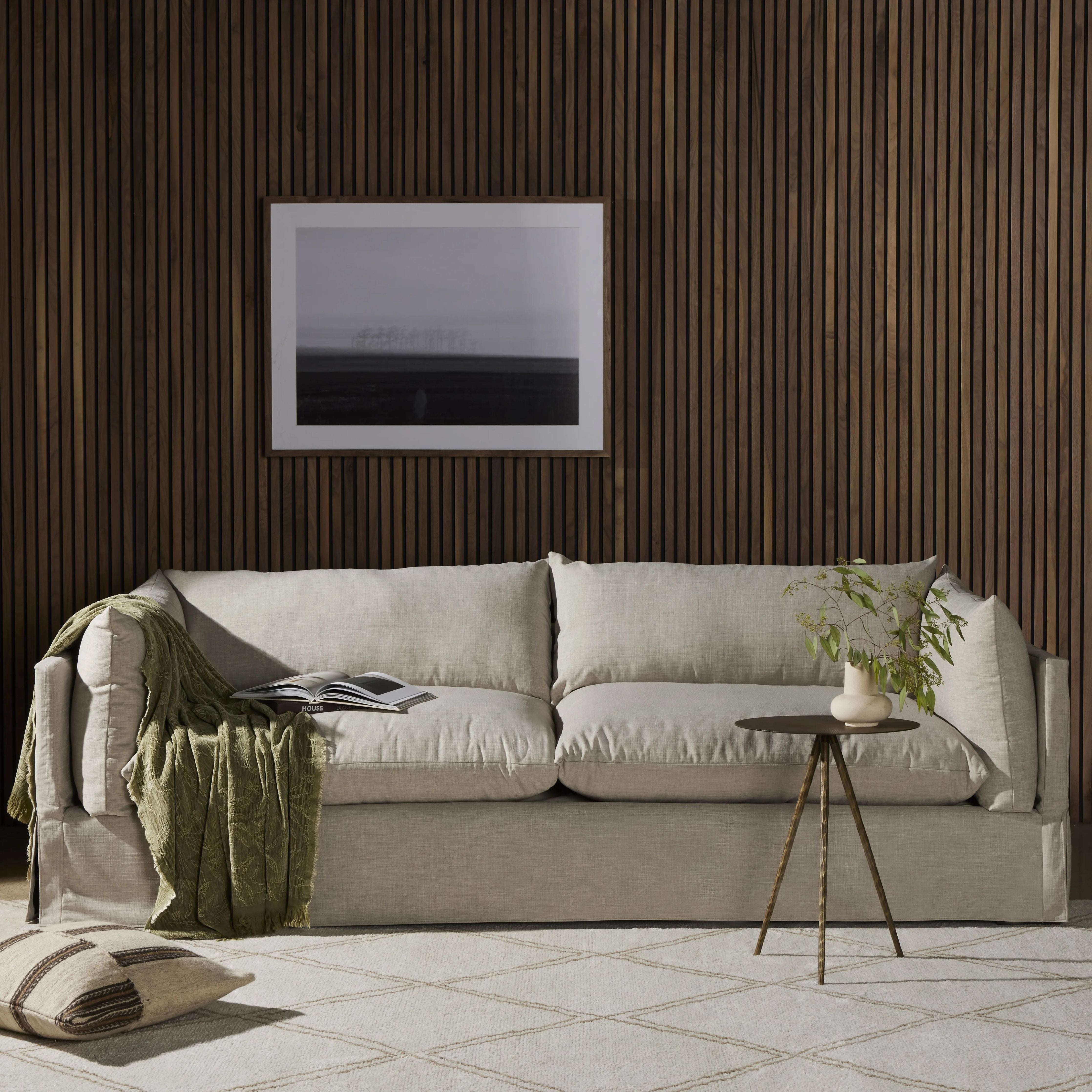 A slipcovered sofa made for modern living. Shelter arms and big, pillow-inspired cushions are covered in a durable, comfortable fabric prime for lounging. Performance fabrics are specially created to withstand spills, stains, high traffic and wear, ensuring long-term comfort and unmatched durability Amethyst Home provides interior design, new home construction design consulting, vintage area rugs, and lighting in the Miami metro area.