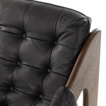 A Seventies-era style inspired by a flea market find, a dramatically tufted sling seat of black top-grain leather angles at the just-right pitch for total comfort, with wide, brown ash framing. Amethyst Home provides interior design, new home construction design consulting, vintage area rugs, and lighting in the Park City metro area.