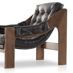 A Seventies-era style inspired by a flea market find, a dramatically tufted sling seat of black top-grain leather angles at the just-right pitch for total comfort, with wide, brown ash framing. Amethyst Home provides interior design, new home construction design consulting, vintage area rugs, and lighting in the San Diego metro area.