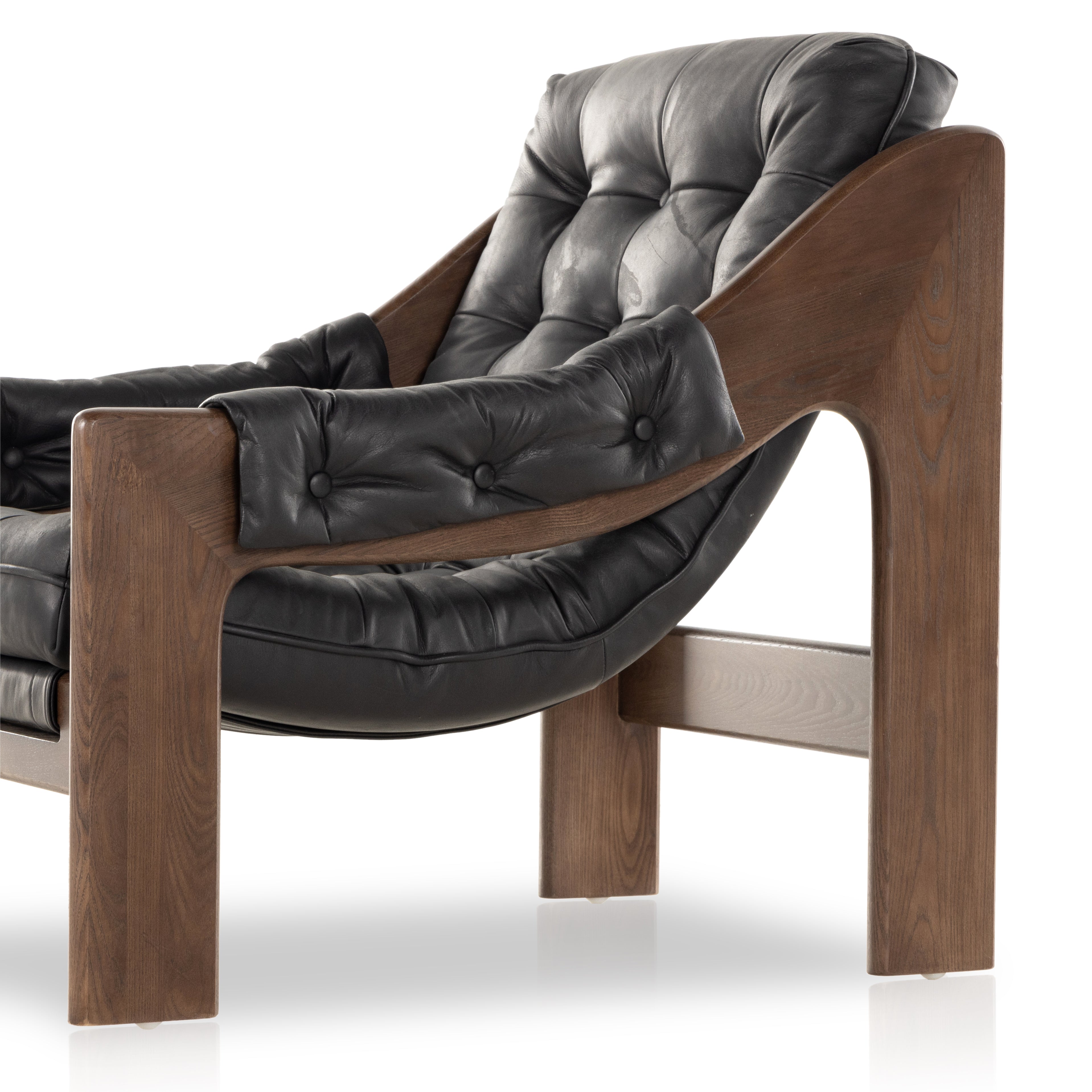 A Seventies-era style inspired by a flea market find, a dramatically tufted sling seat of black top-grain leather angles at the just-right pitch for total comfort, with wide, brown ash framing. Amethyst Home provides interior design, new home construction design consulting, vintage area rugs, and lighting in the San Diego metro area.