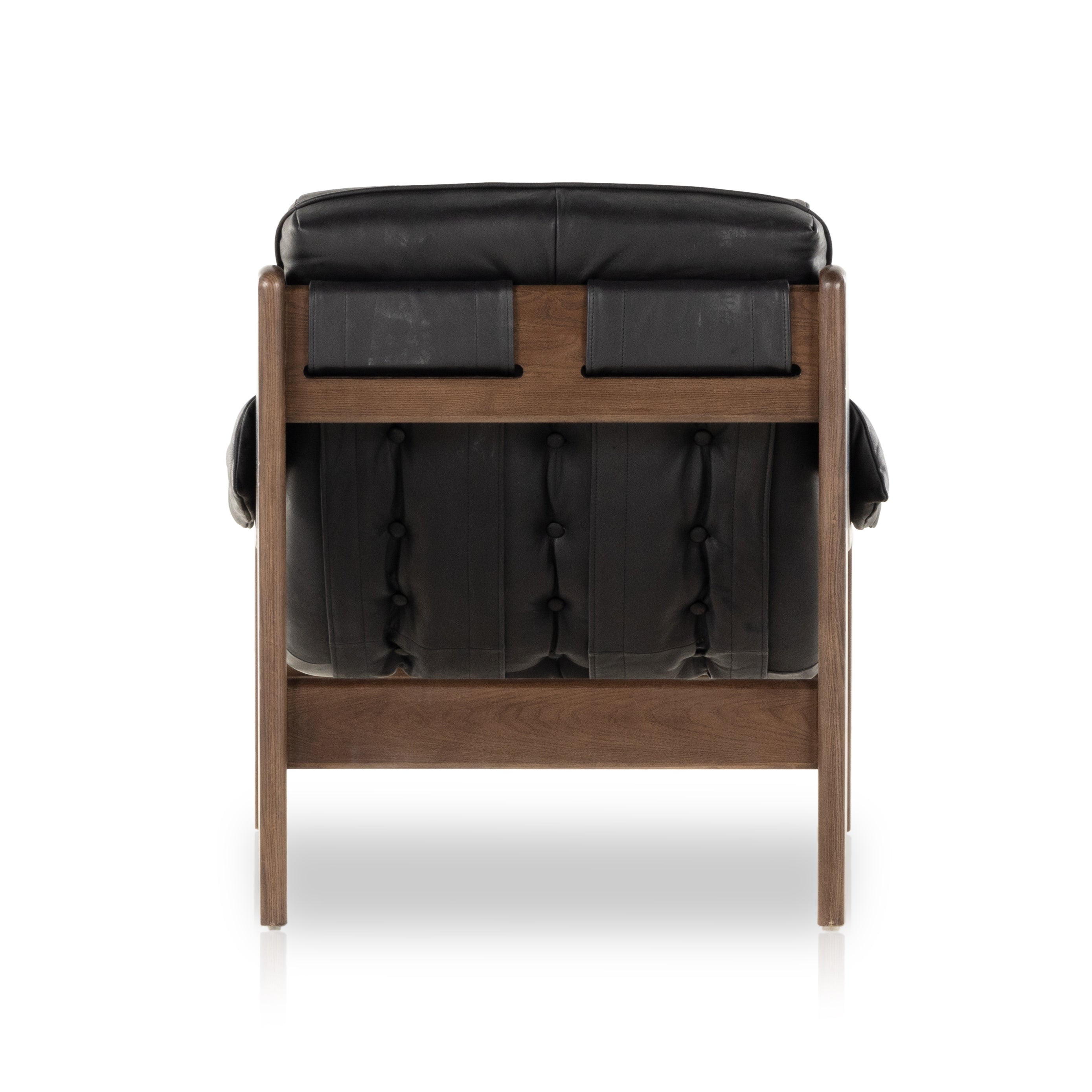 A Seventies-era style inspired by a flea market find, a dramatically tufted sling seat of black top-grain leather angles at the just-right pitch for total comfort, with wide, brown ash framing. Amethyst Home provides interior design, new home construction design consulting, vintage area rugs, and lighting in the Tampa metro area.