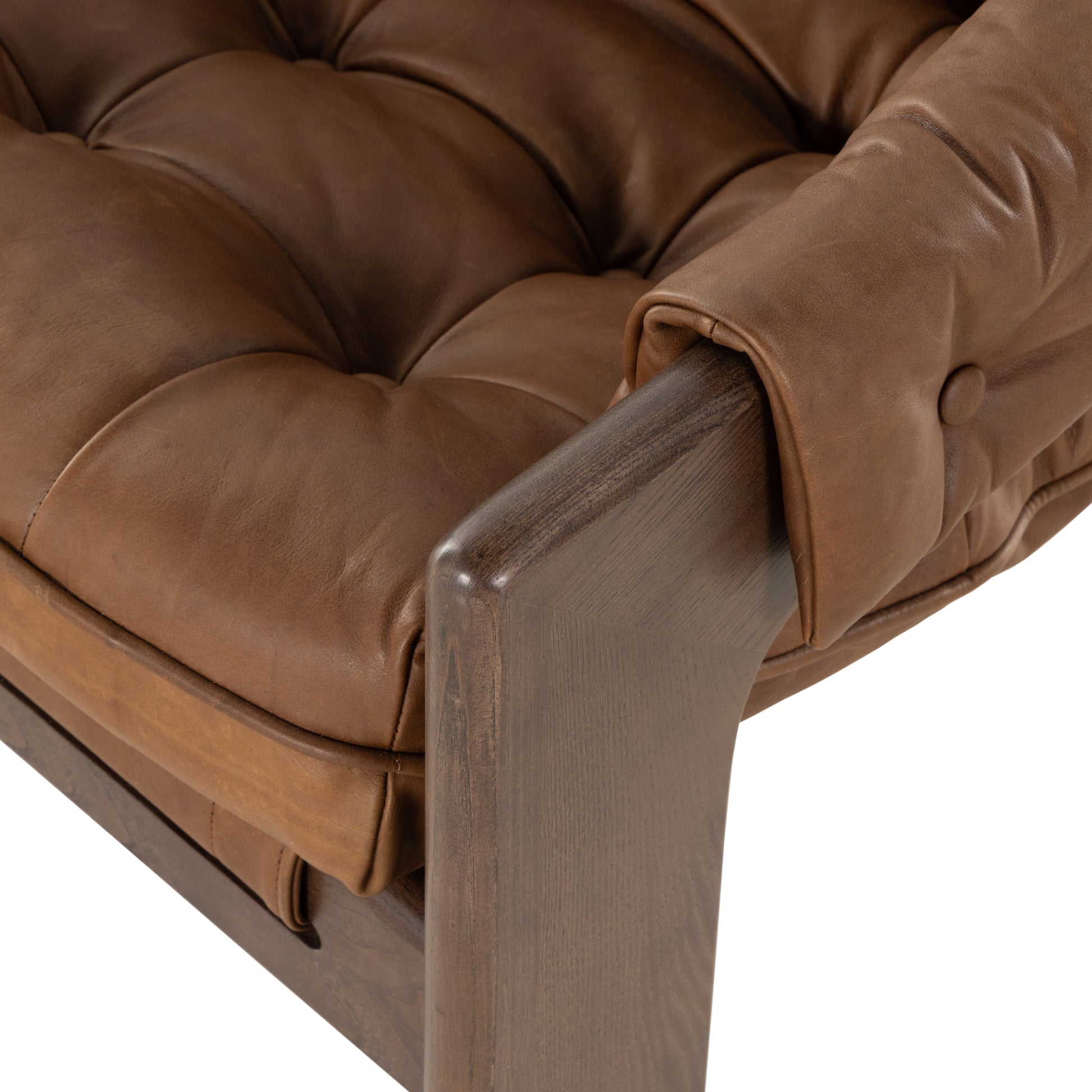 A Seventies-era style inspired by a flea market find, a dramatically tufted sling seat of black top-grain leather angles at the just-right pitch for total comfort, with wide, brown ash framing. Amethyst Home provides interior design, new home construction design consulting, vintage area rugs, and lighting in the Los Angeles metro area.