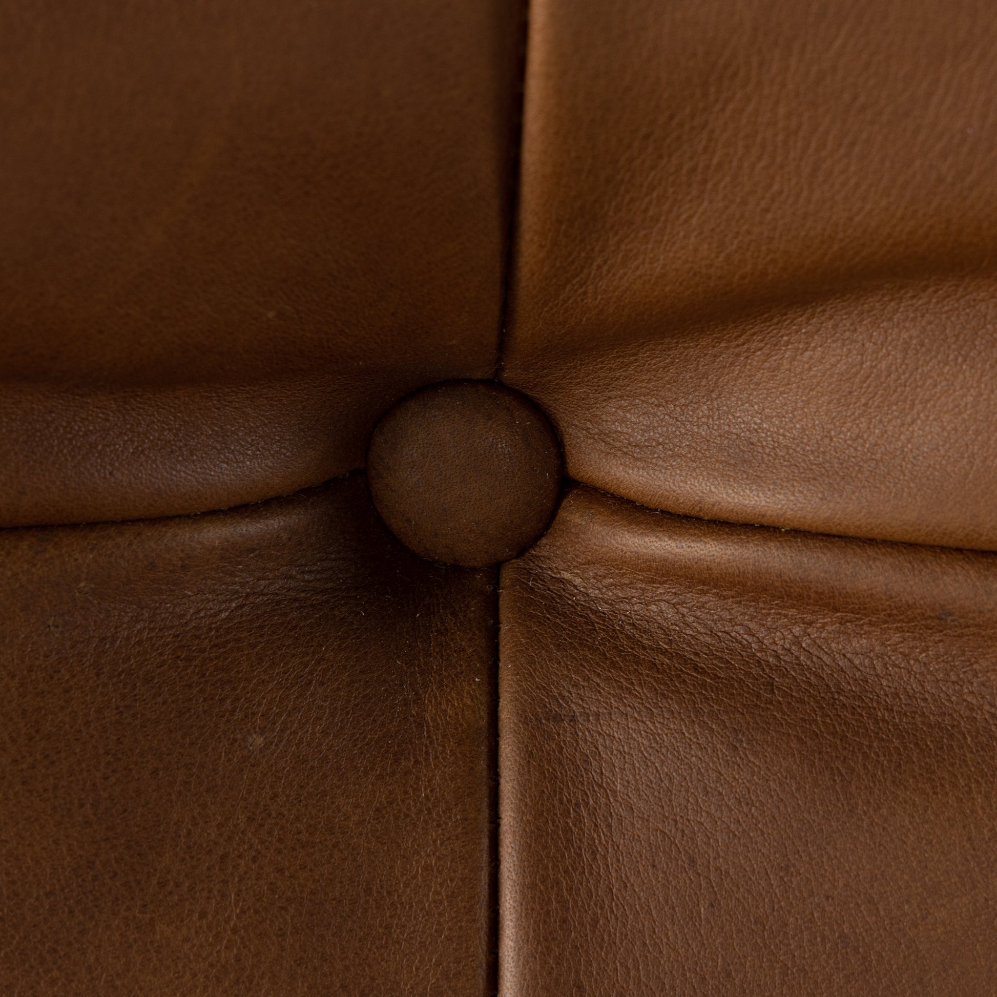 A Seventies-era style inspired by a flea market find, a dramatically tufted sling seat of black top-grain leather angles at the just-right pitch for total comfort, with wide, brown ash framing. Amethyst Home provides interior design, new home construction design consulting, vintage area rugs, and lighting in the Miami metro area.