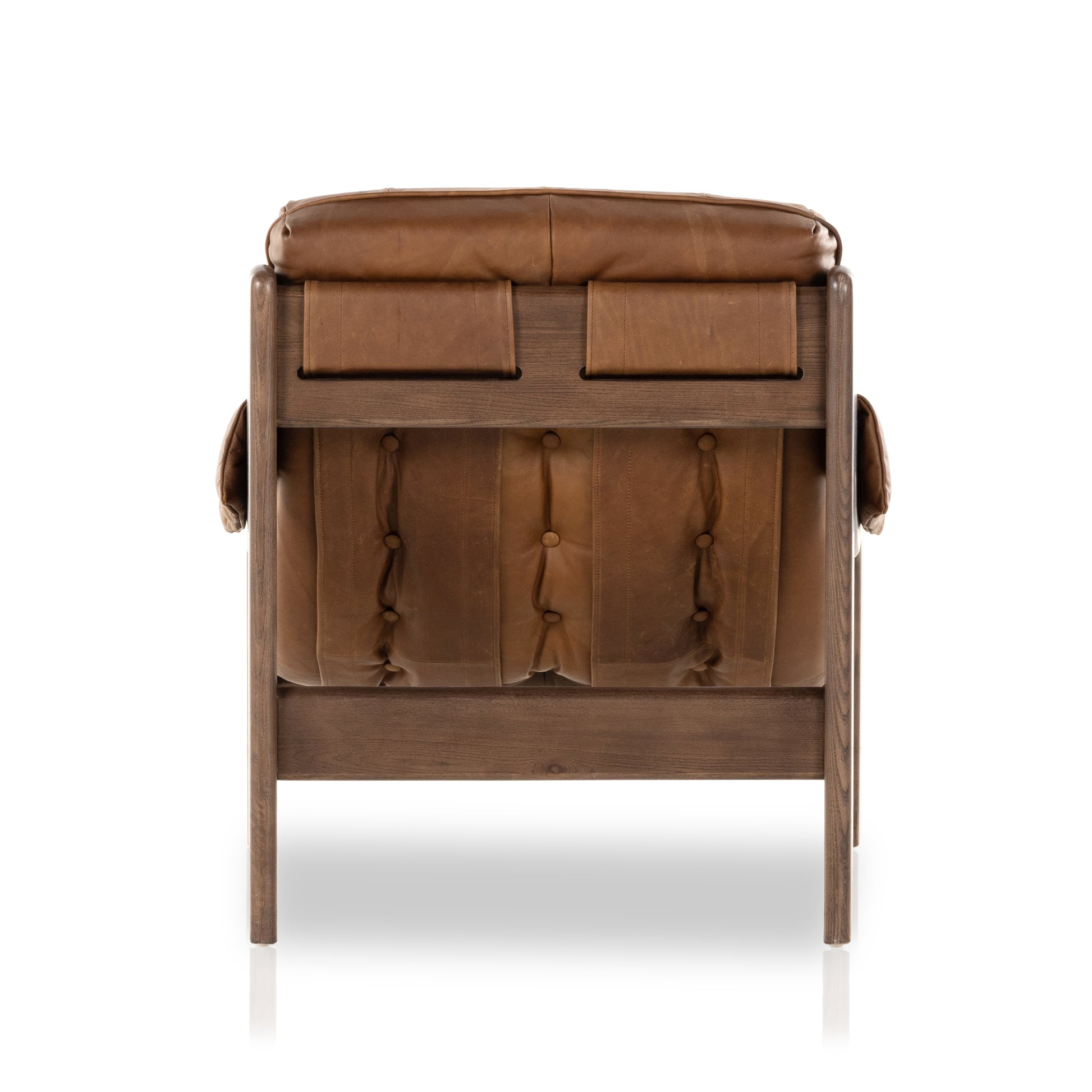 A Seventies-era style inspired by a flea market find, a dramatically tufted sling seat of black top-grain leather angles at the just-right pitch for total comfort, with wide, brown ash framing. Amethyst Home provides interior design, new home construction design consulting, vintage area rugs, and lighting in the Newport Beach metro area.