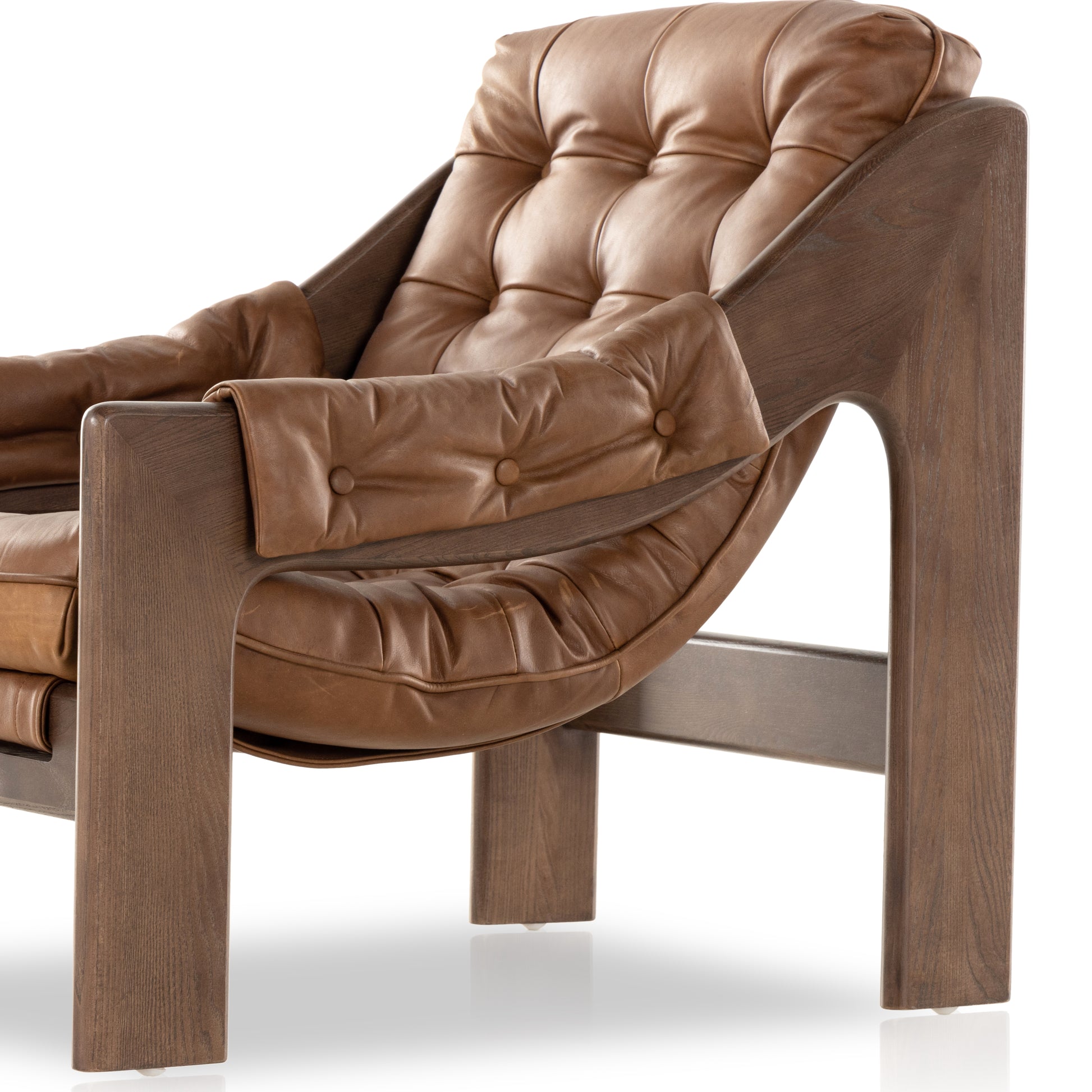 A Seventies-era style inspired by a flea market find, a dramatically tufted sling seat of black top-grain leather angles at the just-right pitch for total comfort, with wide, brown ash framing. Amethyst Home provides interior design, new home construction design consulting, vintage area rugs, and lighting in the Salt Lake City metro area.