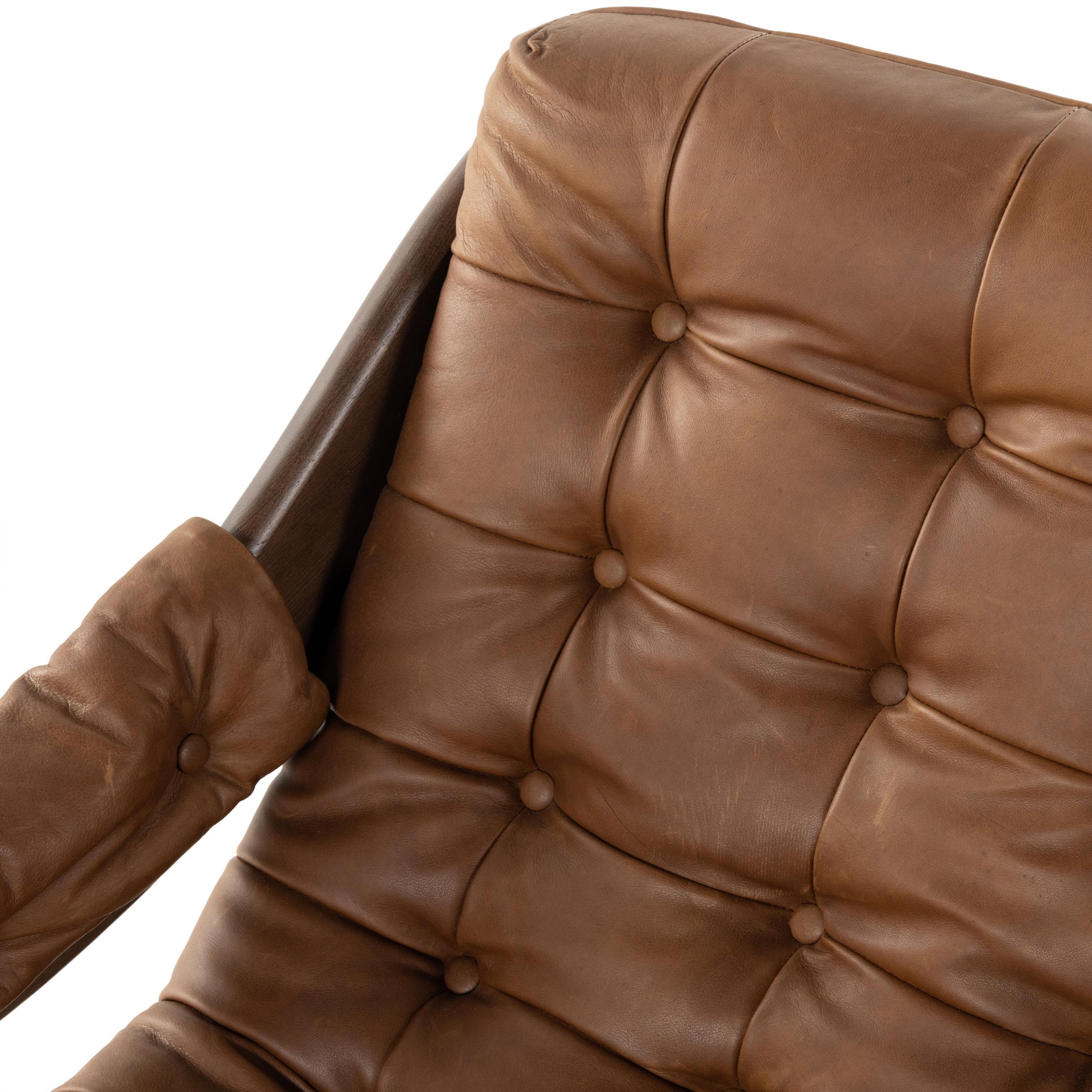 A Seventies-era style inspired by a flea market find, a dramatically tufted sling seat of black top-grain leather angles at the just-right pitch for total comfort, with wide, brown ash framing. Amethyst Home provides interior design, new home construction design consulting, vintage area rugs, and lighting in the Washington metro area.