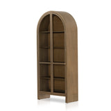 Ilana Burnished Mindi Cabinet forms a dramatic arch this glass-front cabinetry, with woven natural cane backing for a textural finishing touch. Amethyst Home provides interior design services, furniture, rugs, and lighting in the Los Angeles metro area.