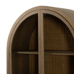 Ilana Burnished Mindi Cabinet forms a dramatic arch this glass-front cabinetry, with woven natural cane backing for a textural finishing touch. Amethyst Home provides interior design services, furniture, rugs, and lighting in the Seattle metro area.