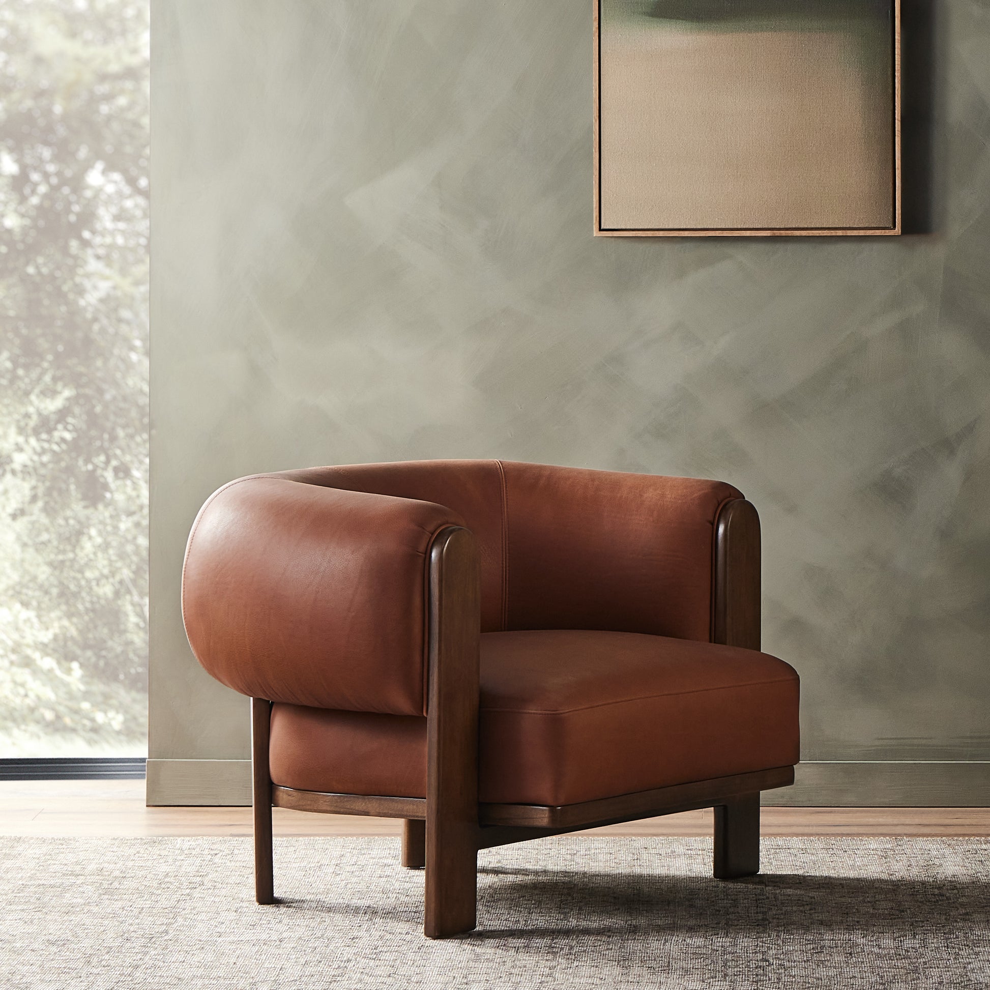A 60s-era design is re-envisioned with an exposed parawood frame, thick-cut Brazilian leather and overinflated arms that provide cushion all around. Designed with an extra-thick seat cushioning with S spring construction for a plush, supportive sit. Amethyst Home provides interior design, new construction, custom furniture, and area rugs in the Omaha metro area.