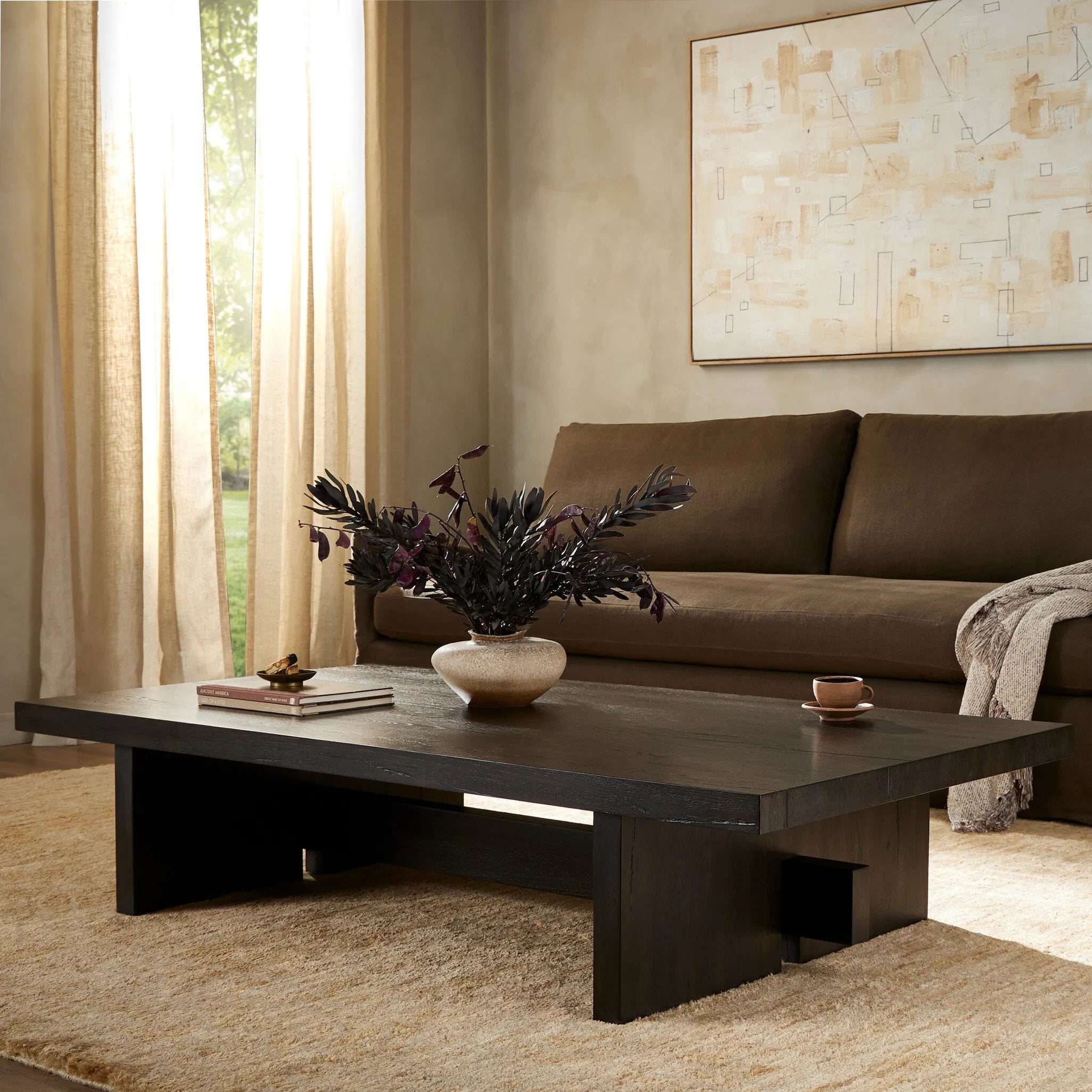 A substantially sized coffee table of smoked black oak features joint and connection construction for a design-forward look. Visible knots and graining add character.Collection: Haide Amethyst Home provides interior design, new home construction design consulting, vintage area rugs, and lighting in the Seattle metro area.