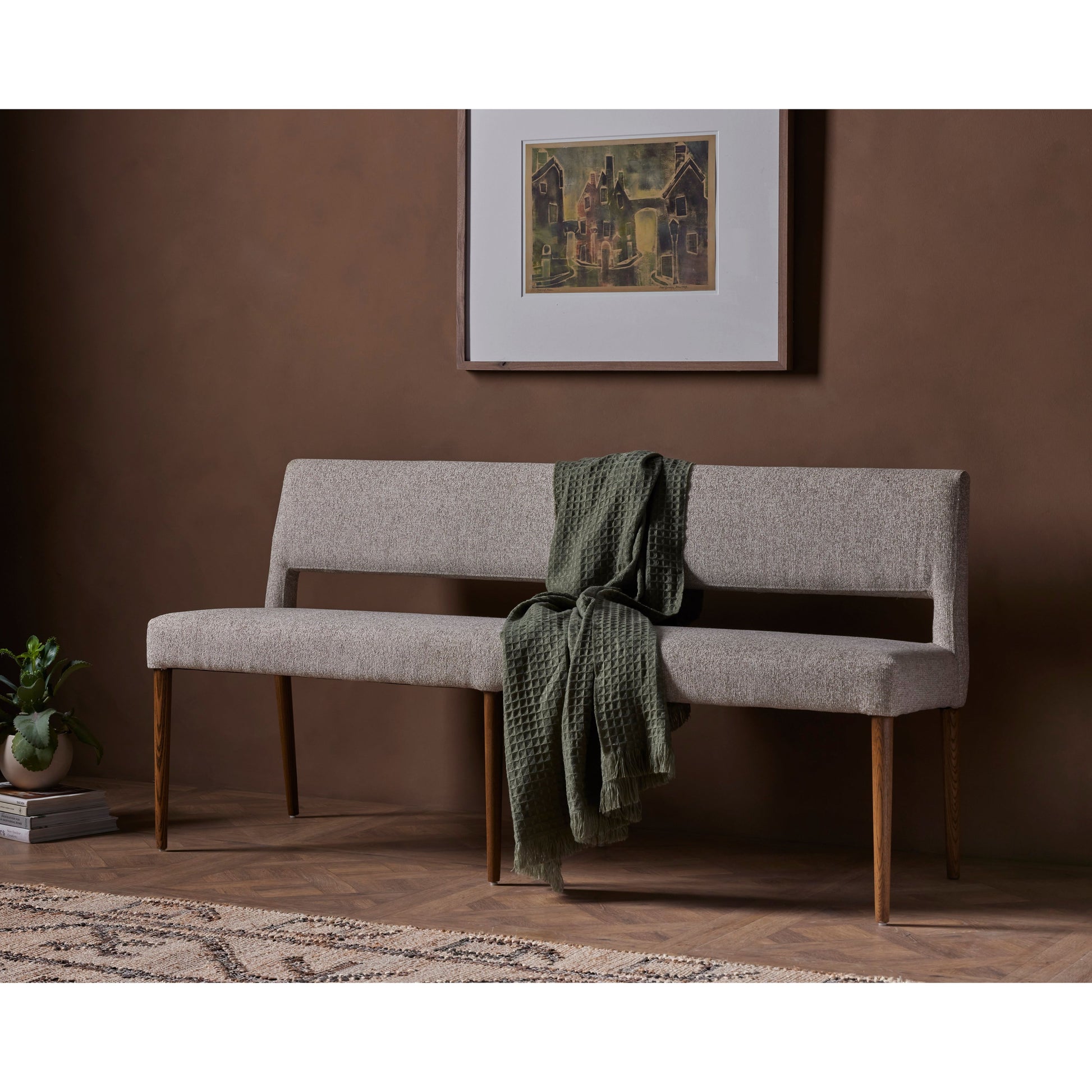 Simply styled and midcentury-minded, Joseph Light Camel Dining Bench is a textural light taupe upholstery that features a posterior cutout for added flair, with toasted nettlewood legs for natural contrast. Amethyst Home provides interior design services, furniture, rugs, and lighting in the Calabasas metro area.