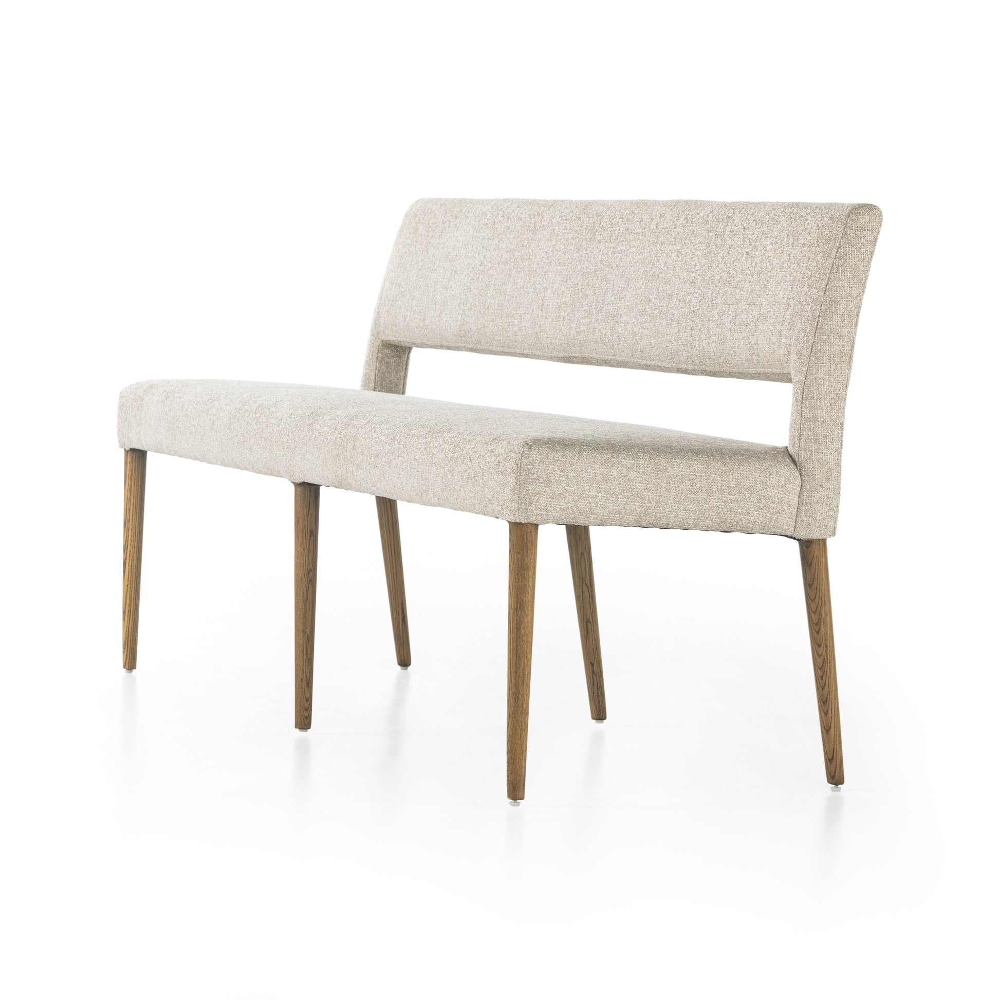 Simply styled and midcentury-minded, Joseph Light Camel Dining Bench is a textural light taupe upholstery that features a posterior cutout for added flair, with toasted nettlewood legs for natural contrast. Amethyst Home provides interior design services, furniture, rugs, and lighting in the Des Moines metro area. 