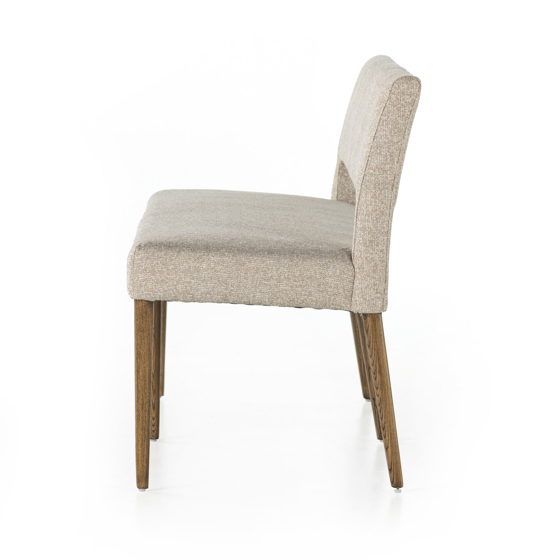 Simply styled and midcentury-minded, Joseph Light Camel Dining Bench is a textural light taupe upholstery that features a posterior cutout for added flair, with toasted nettlewood legs for natural contrast. Amethyst Home provides interior design services, furniture, rugs, and lighting in the Portland metro area. 