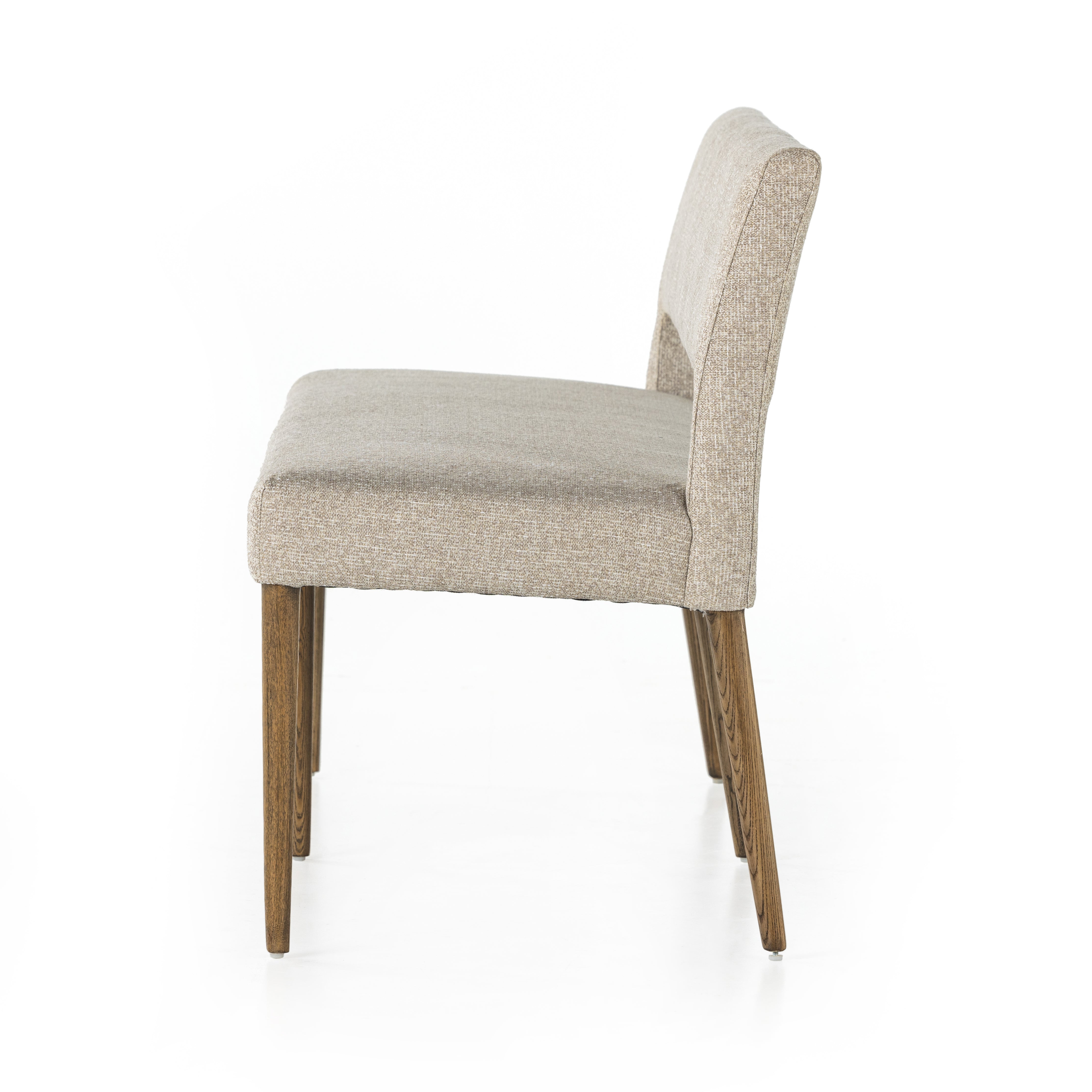 Simply styled and midcentury-minded, Joseph Light Camel Dining Bench is a textural light taupe upholstery that features a posterior cutout for added flair, with toasted nettlewood legs for natural contrast. Amethyst Home provides interior design services, furniture, rugs, and lighting in the Portland metro area. 