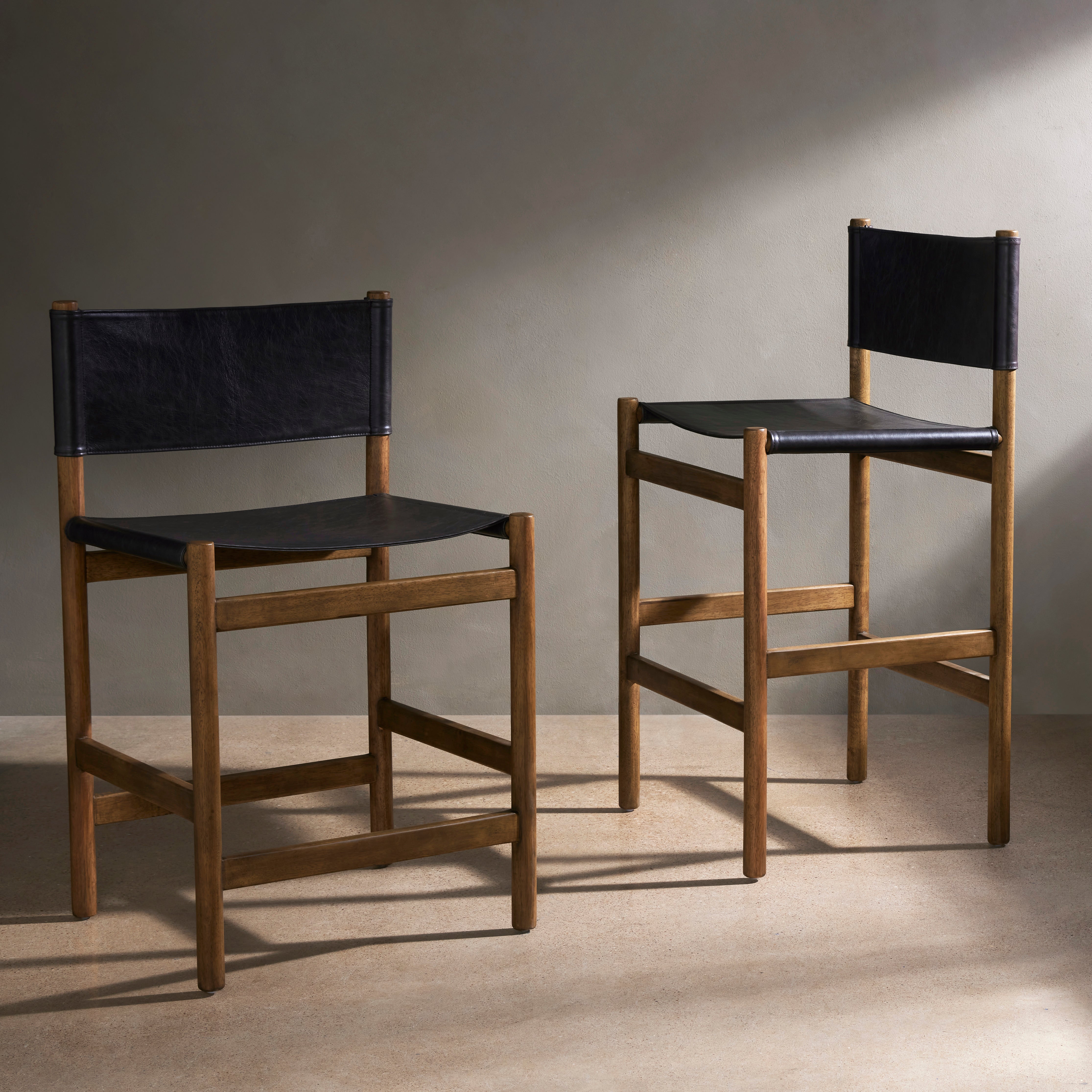 Solid parawood forms a simple, vintage-inspired frame for sling-style seating of black top-grain leather exclusive to Four Hands. Perfectly sized for the counter. Amethyst Home provides interior design, new construction, custom furniture, and area rugs in the Boston metro area.