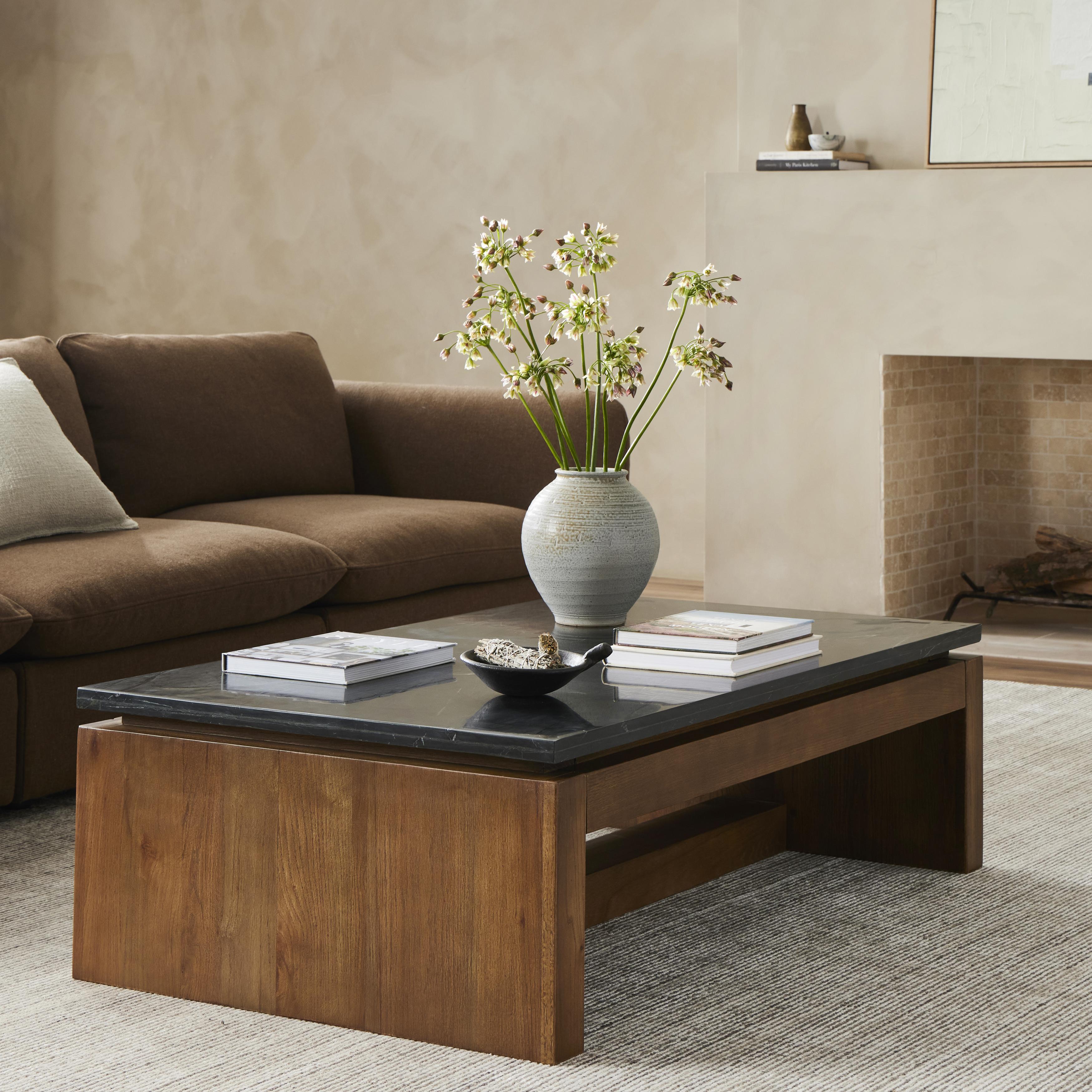 Mixed materials update this waterfall-style coffee table, as a warm oak base pairs with a sleek black marble tabletop. Amethyst Home provides interior design, new construction, custom furniture, and area rugs in the Park City metro area.