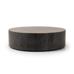 A cylinder-shaped coffee tables brings a shapely look to the living room. Made from natural polished bluestone for an organic look and feel.Collection: Hughe Amethyst Home provides interior design, new home construction design consulting, vintage area rugs, and lighting in the Portland metro area.