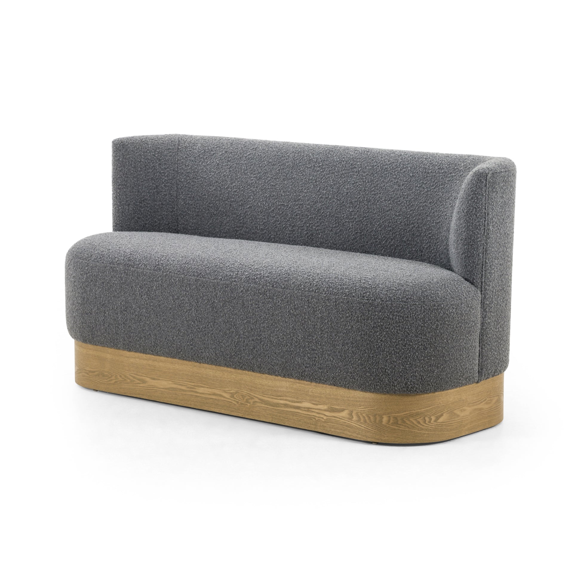 Style takes shape. Comfortably curved bench seating is upholstered in a chunky charcoal boucle, with water-repellent high-performance fabric for modern sensibility. A plinth-style ash veneer base works casual contrast into the mix. Perfectly sized for a cozy breakfast nook; pair up to suit a larger space. Amethyst Home provides interior design, new home construction design consulting, vintage area rugs, and lighting in the Houston metro area.