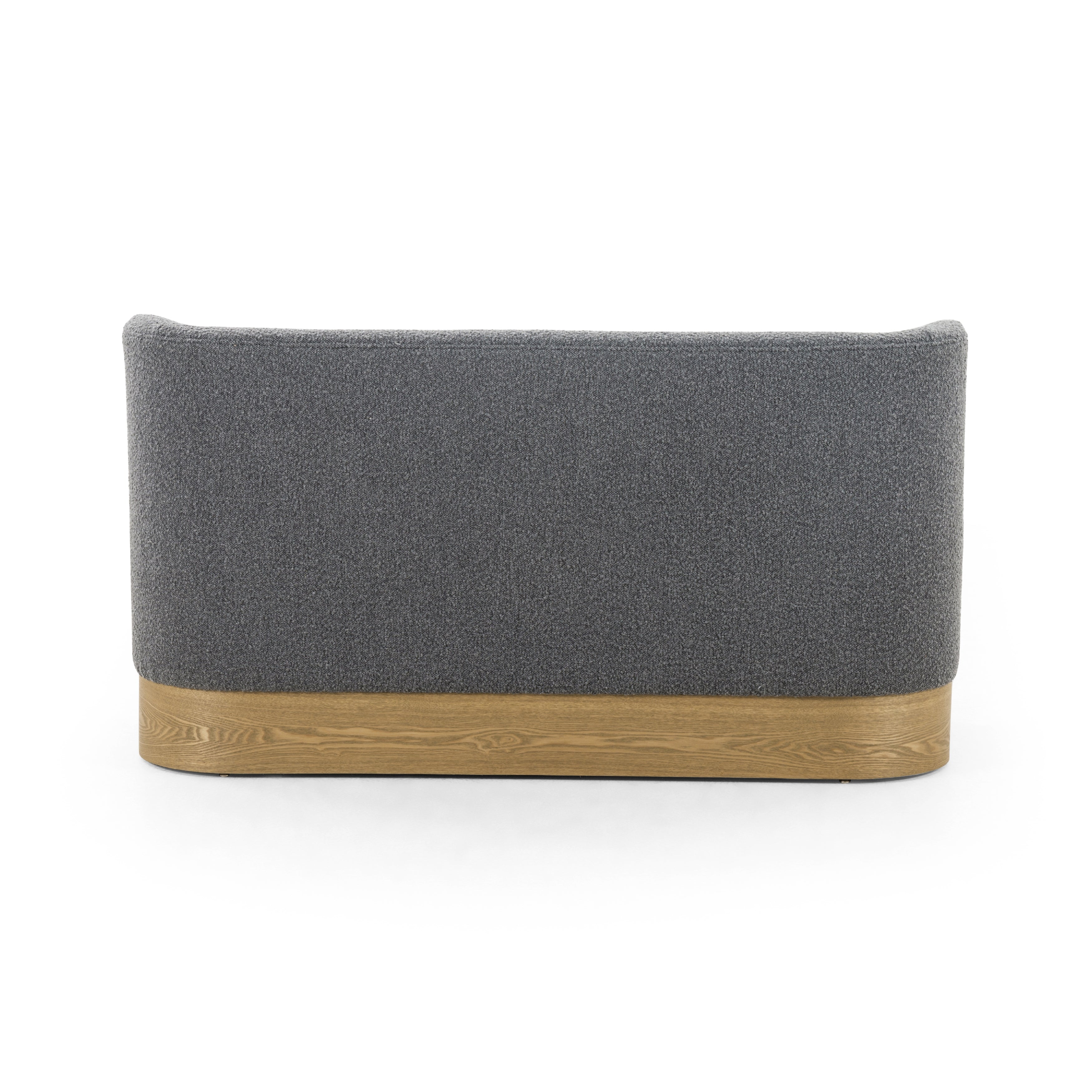 Style takes shape. Comfortably curved bench seating is upholstered in a chunky charcoal boucle, with water-repellent high-performance fabric for modern sensibility. A plinth-style ash veneer base works casual contrast into the mix. Perfectly sized for a cozy breakfast nook; pair up to suit a larger space. Amethyst Home provides interior design, new home construction design consulting, vintage area rugs, and lighting in the Washington metro area.