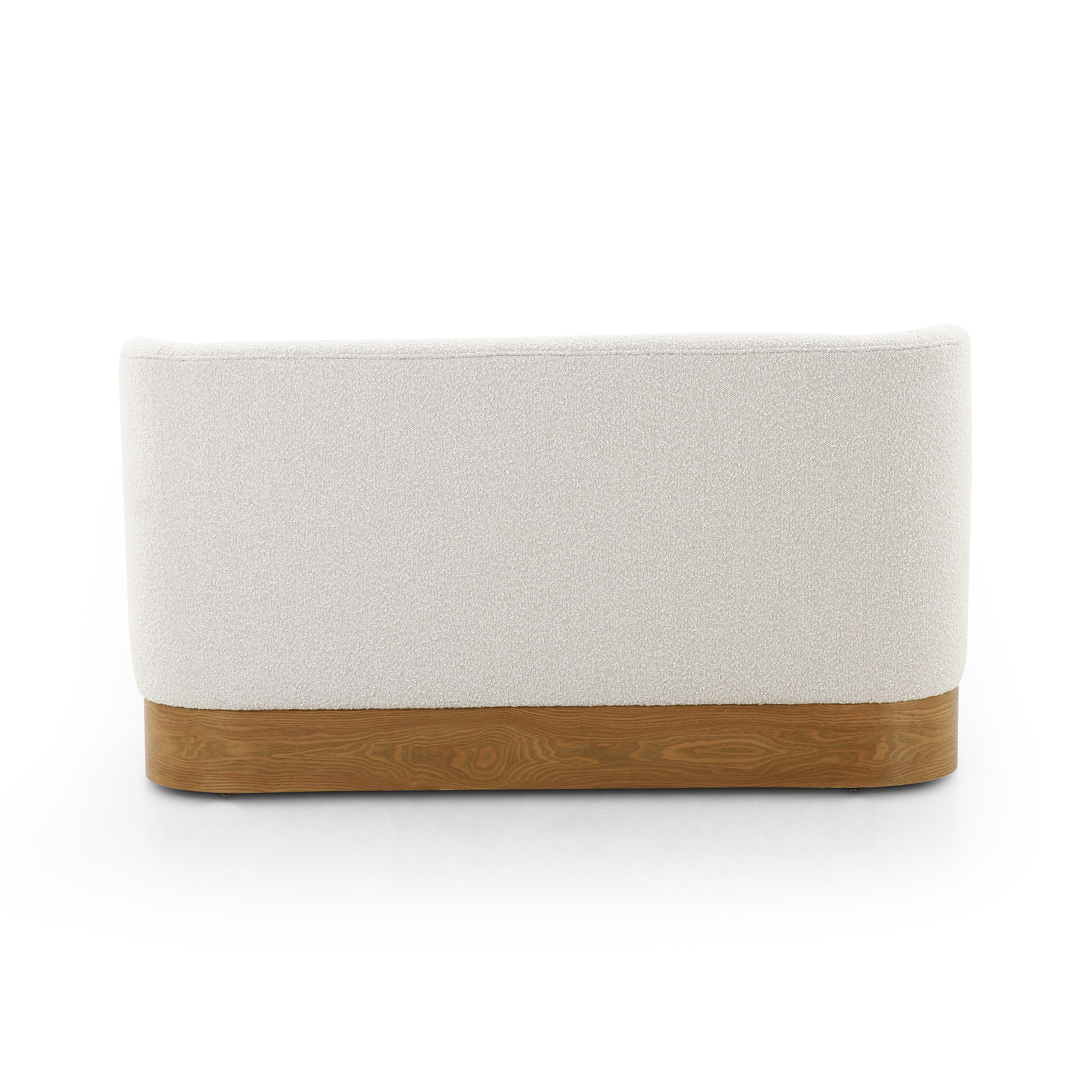 Featuring Krista Knoll Natural Dining Bench by Four Hands at Amethyst Home. Style takes shape. Comfortably curved bench seating is upholstered in a chunky off-white boucle, with water-repellent performance fabric for a modern touch. A plinth-style ash veneer base works casual contrast into the mix. Perfectly sized for a cozy breakfast nook; pair up to suit a l. Amethyst Home provides interior design, new home construction design consulting, vintage area rugs, and lighting in the Boston metro area.