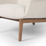 The classic wingback chair is updated with a midcentury-style base. Flared arms and a high winged back with blind tufting offer all-around comfort. Upholstered in a heavily textured boucle performance fabric bringing movement and everyday function to the piece. Amethyst Home provides interior design, new construction, custom furniture, and area rugs in the Nashville metro area.