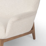 The classic wingback chair is updated with a midcentury-style base. Flared arms and a high winged back with blind tufting offer all-around comfort. Upholstered in a heavily textured boucle performance fabric bringing movement and everyday function to the piece. Amethyst Home provides interior design, new construction, custom furniture, and area rugs in the Park City metro area.