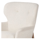 The classic wingback chair is updated with a midcentury-style base. Flared arms and a high winged back with blind tufting offer all-around comfort. Upholstered in a heavily textured boucle performance fabric bringing movement and everyday function to the piece. Amethyst Home provides interior design, new construction, custom furniture, and area rugs in the Portland metro area.