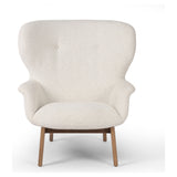 The classic wingback chair is updated with a midcentury-style base. Flared arms and a high winged back with blind tufting offer all-around comfort. Upholstered in a heavily textured boucle performance fabric bringing movement and everyday function to the piece. Amethyst Home provides interior design, new construction, custom furniture, and area rugs in the Salt Lake City metro area.