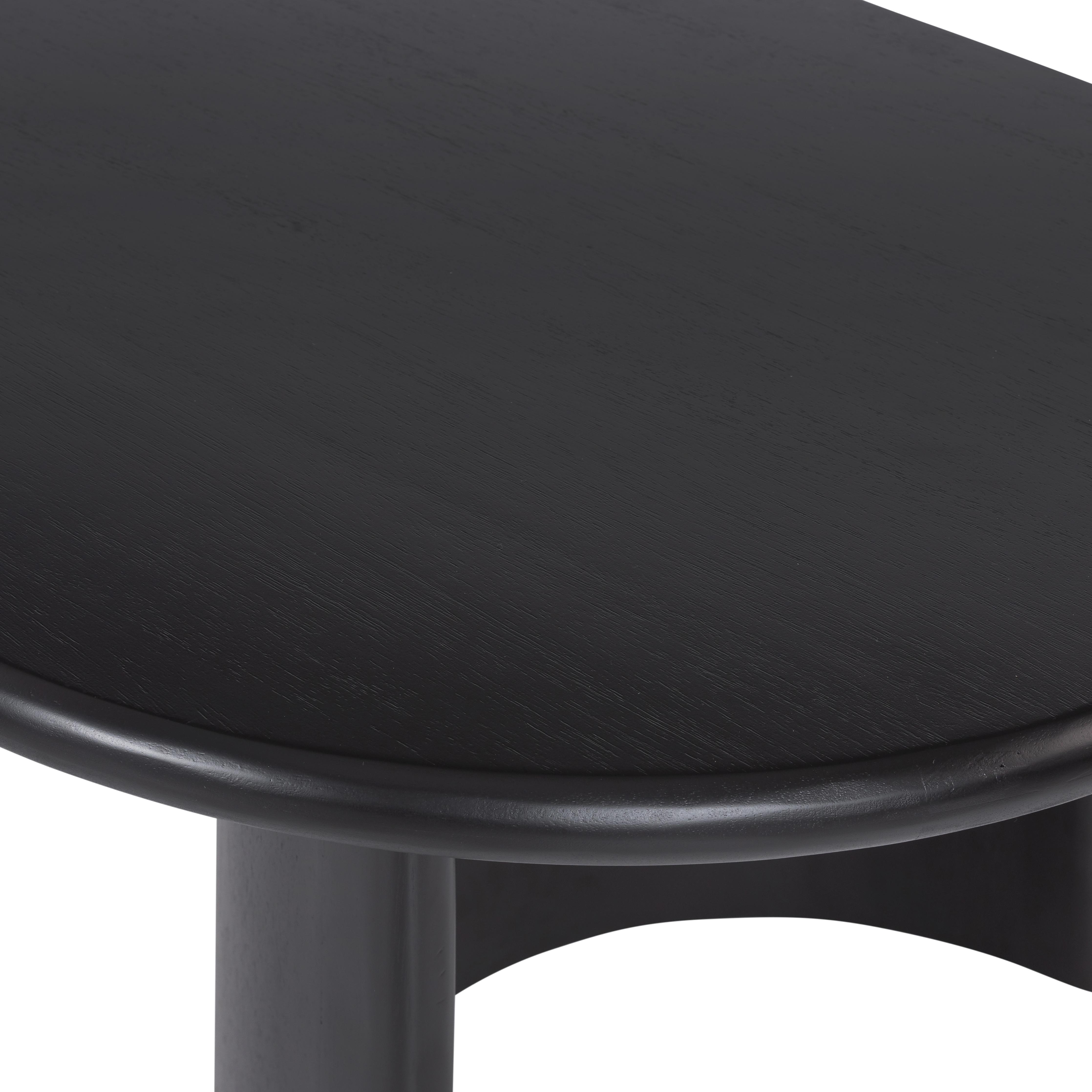 A study in shape. Black acacia forms crescent-shaped legs and sprawling oval tabletop, bringing organic presence to the living room. Amethyst Home provides interior design, new home construction design consulting, vintage area rugs, and lighting in the Alpharetta metro area.