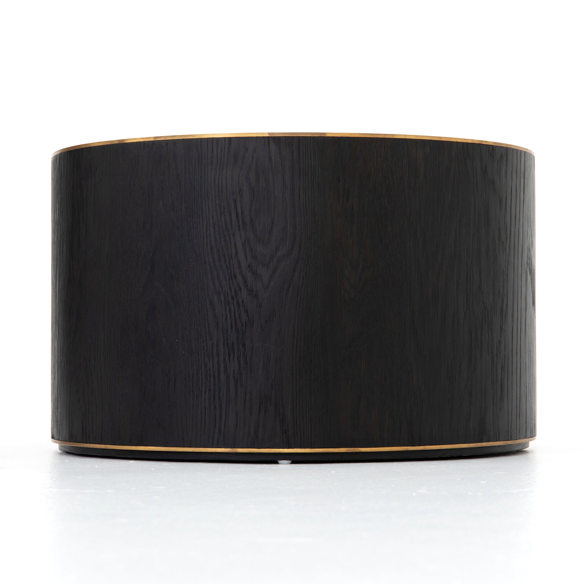 Bring on the drama. An ebony-finished oak top is cut in a starburst texture, framed by deep ebony sides, and encircled by bright brass-clad binding. Amethyst Home provides interior design, new construction, custom furniture, and area rugs in the Seattle metro area.