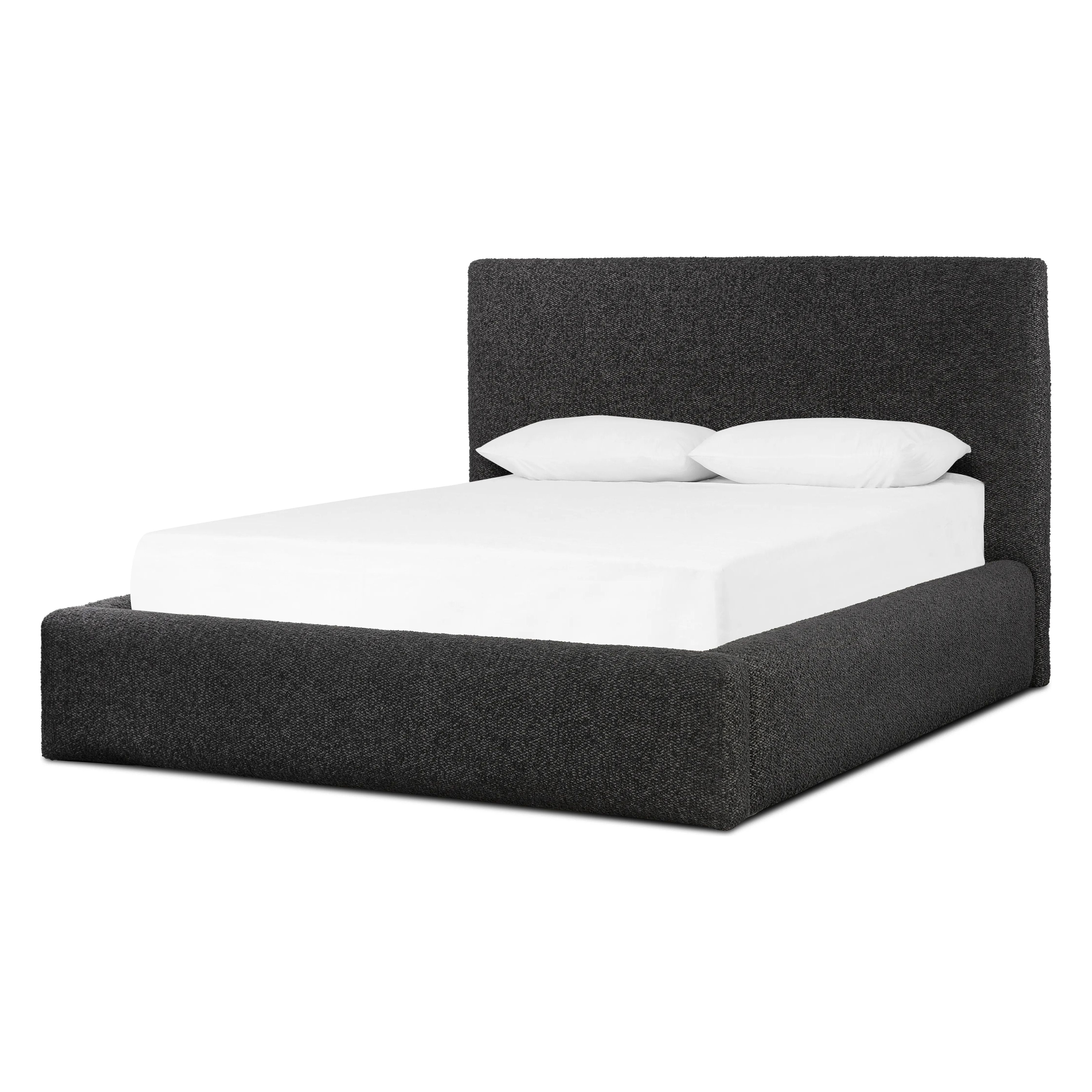 Modern, clean shaping meets inflated comfort with this padded, upholstered bed frame in a textural boucle-like pattern Amethyst Home provides interior design, new home construction design consulting, vintage area rugs, and lighting in the Los Angeles metro area.