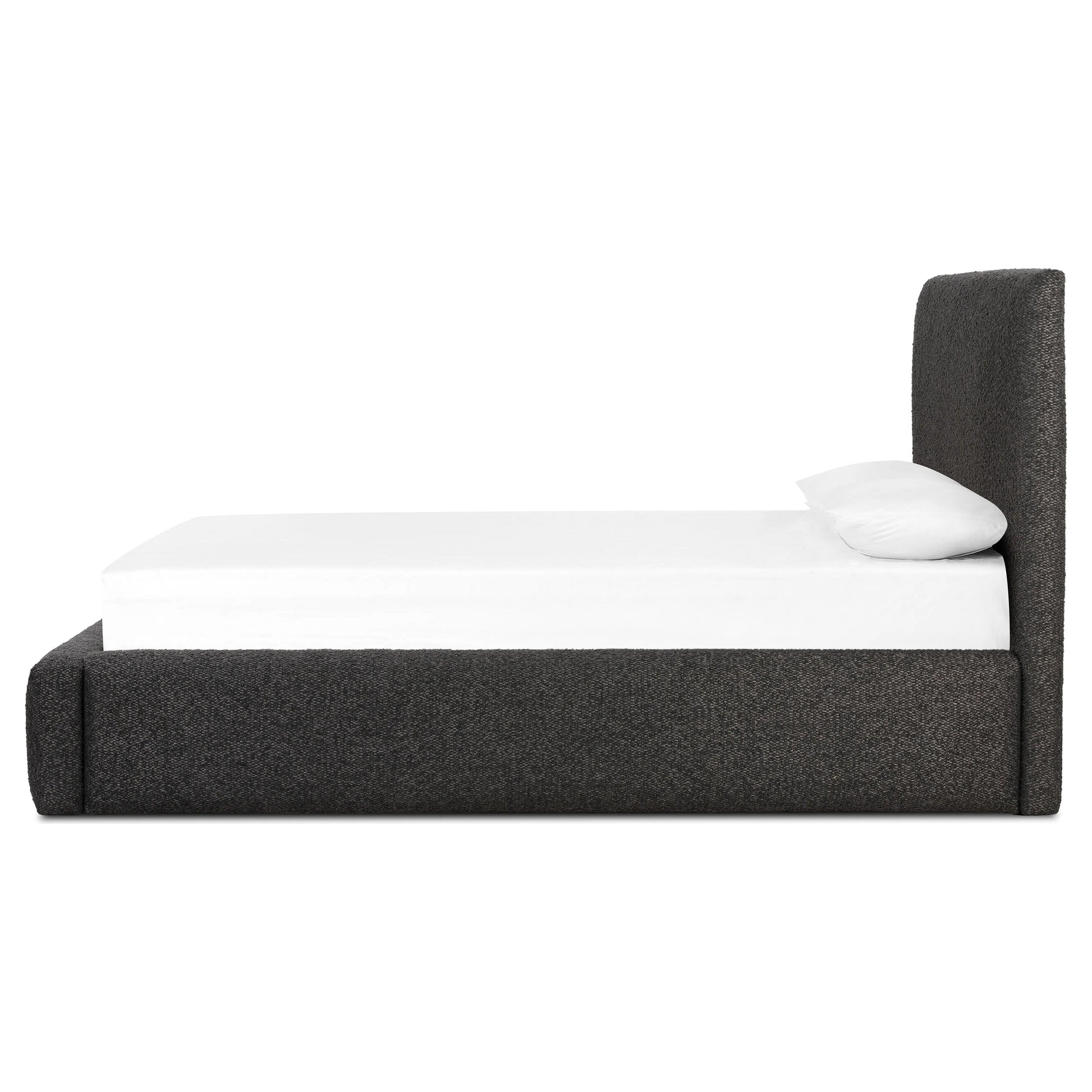 Modern, clean shaping meets inflated comfort with this padded, upholstered bed frame in a textural boucle-like pattern Amethyst Home provides interior design, new home construction design consulting, vintage area rugs, and lighting in the Portland metro area.