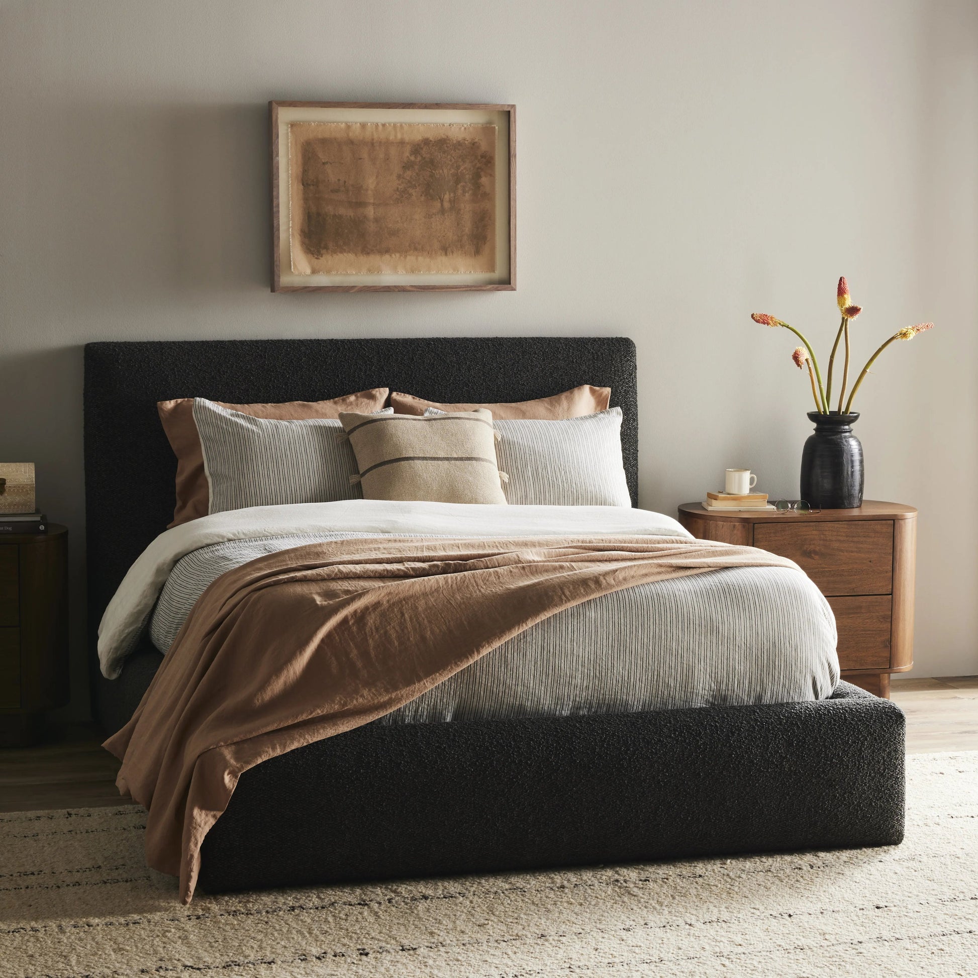 Modern, clean shaping meets inflated comfort with this padded, upholstered bed frame in a textural boucle-like pattern Amethyst Home provides interior design, new home construction design consulting, vintage area rugs, and lighting in the Salt Lake City metro area.