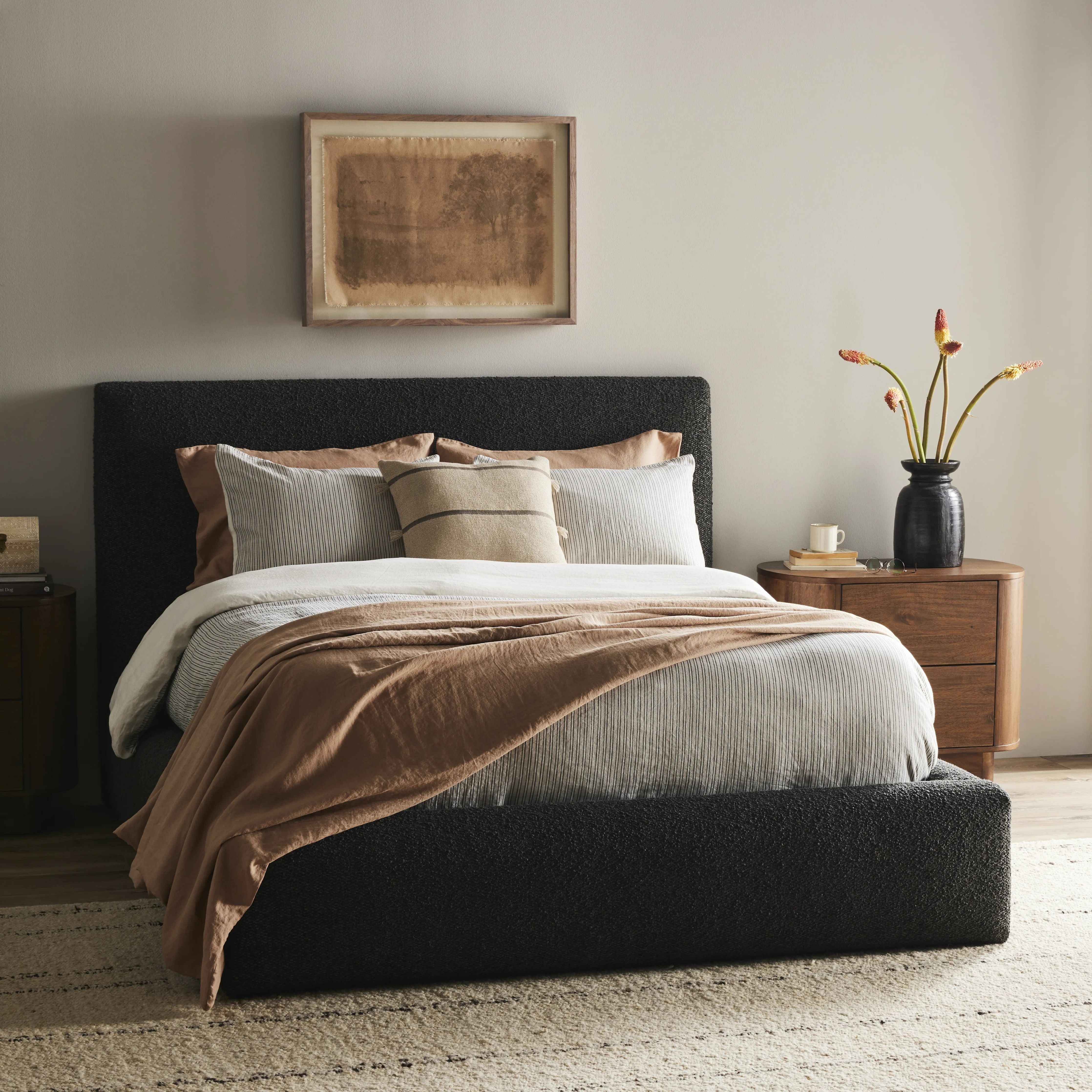 Modern, clean shaping meets inflated comfort with this padded, upholstered bed frame in a textural boucle-like pattern Amethyst Home provides interior design, new home construction design consulting, vintage area rugs, and lighting in the Salt Lake City metro area.