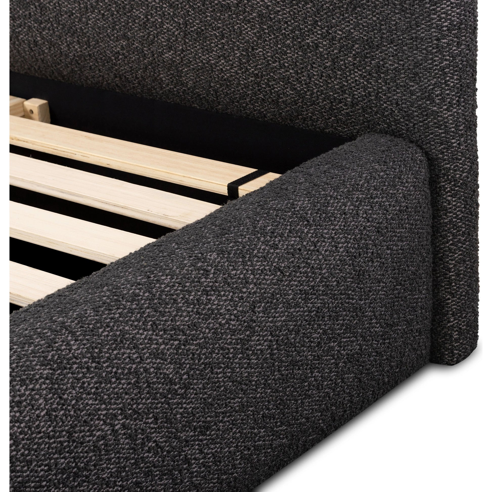 Modern, clean shaping meets inflated comfort with this padded, upholstered bed frame in a textural boucle-like pattern Amethyst Home provides interior design, new home construction design consulting, vintage area rugs, and lighting in the Seattle metro area.