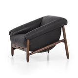 Featuring Reggie Heirloom Black Chair by Four Hands at Amethyst Home. Oversized cushioning brings a Brazilian midcentury feel to this vintage-inspired chair. Designed with cushion-wrapped slanted arms, fixed cushioning with a deep sit and narrow legs reminiscent of midcentury style. Upholstered in heirloom leather. Sourced from one of the oldest family-own. Amethyst Home provides interior design, new home construction design consulting, vintage area rugs, and lighting in the Alpharetta metro area.