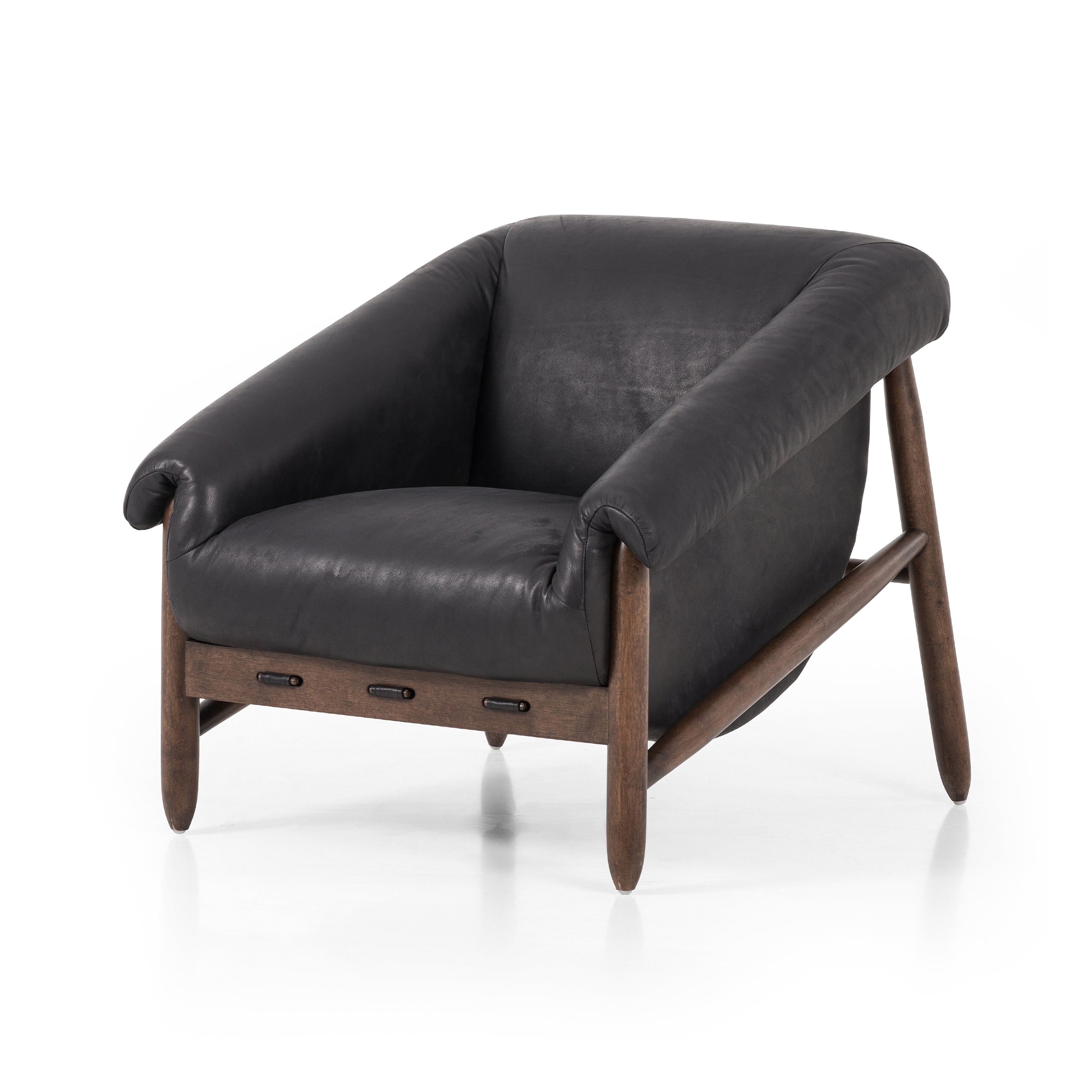 Featuring Reggie Heirloom Black Chair by Four Hands at Amethyst Home. Oversized cushioning brings a Brazilian midcentury feel to this vintage-inspired chair. Designed with cushion-wrapped slanted arms, fixed cushioning with a deep sit and narrow legs reminiscent of midcentury style. Upholstered in heirloom leather. Sourced from one of the oldest family-owned t. Amethyst Home provides interior design, new home construction design consulting, vintage area rugs, and lighting in the Boston metro area.