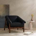 Featuring Reggie Heirloom Black Chair by Four Hands at Amethyst Home. Oversized cushioning brings a Brazilian midcentury feel to this vintage-inspired chair. Designed with cushion-wrapped slanted arms, fixed cushioning with a deep sit and narrow legs reminiscent of midcentury style. Upholstered in heirloom leather. Sourced from one of the oldest family-ow. Amethyst Home provides interior design, new home construction design consulting, vintage area rugs, and lighting in the Kansas City metro area.