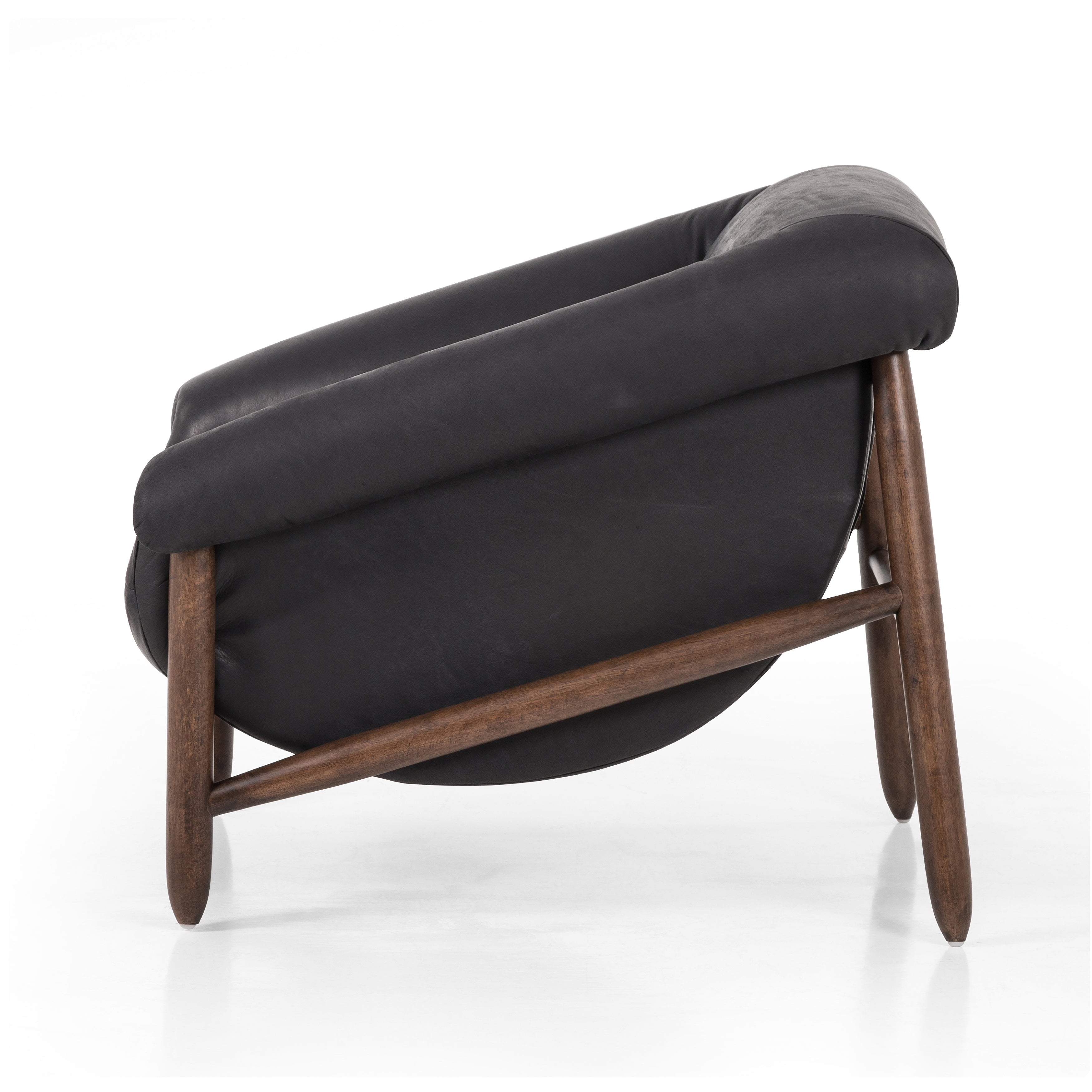 Featuring Reggie Heirloom Black Chair by Four Hands at Amethyst Home. Oversized cushioning brings a Brazilian midcentury feel to this vintage-inspired chair. Designed with cushion-wrapped slanted arms, fixed cushioning with a deep sit and narrow legs reminiscent of midcentury style. Upholstered in heirloom leather. Sourced from one of the oldest family-owned ta. Amethyst Home provides interior design, new home construction design consulting, vintage area rugs, and lighting in the Miami metro area.