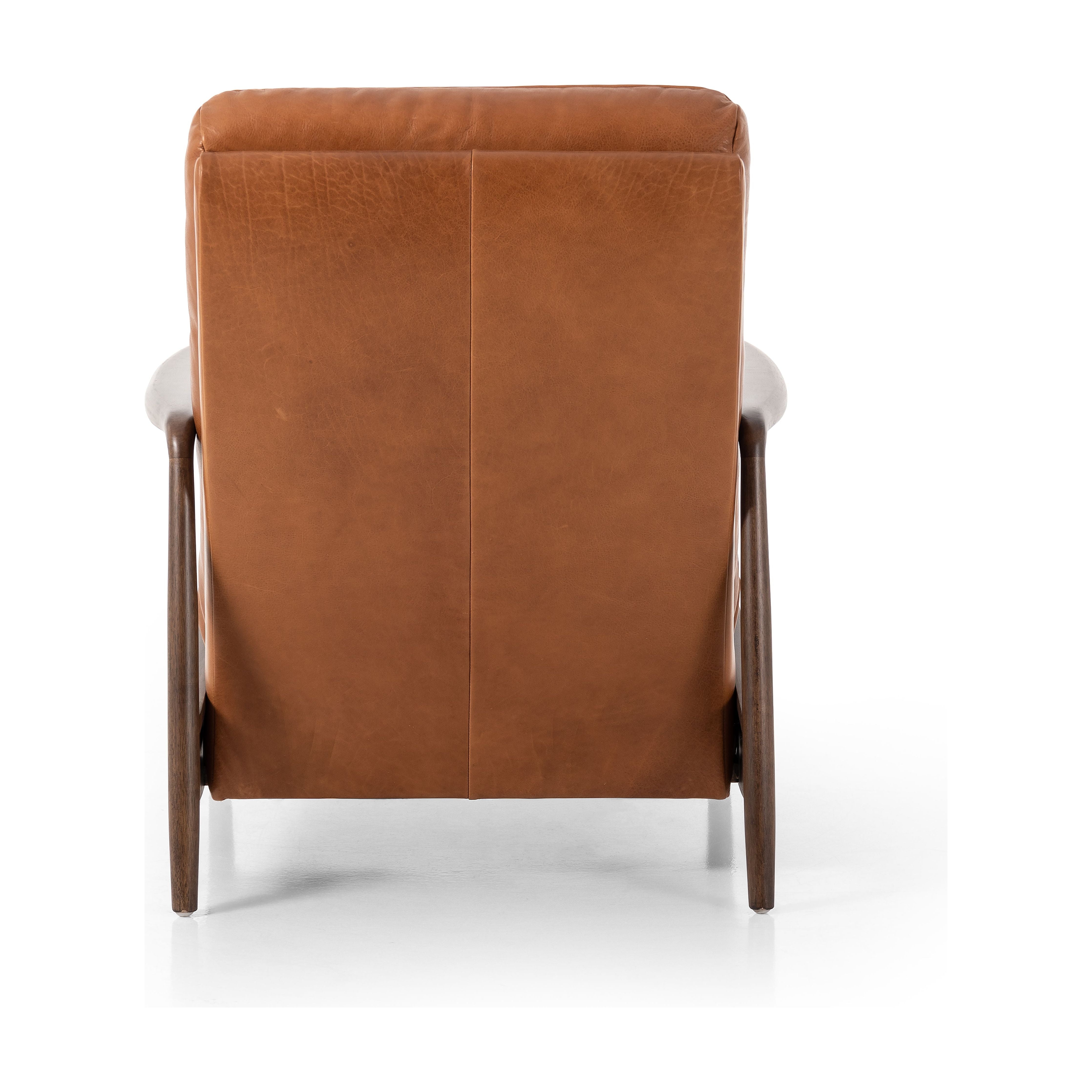 A sleek seat with hidden push-back reclining functionality. This midcentury-inspired recliner features wide chunky channeling paired with slim paddle arms and a tapered wood frame. Designed with a high seat and high back for extra comfy support. Upholstered in a timeless tobacco-hued leather made in a family-owned tannery in Thailand. Amethyst Home provides interior design, new construction, custom furniture, and area rugs in the Salt Lake City metro area.