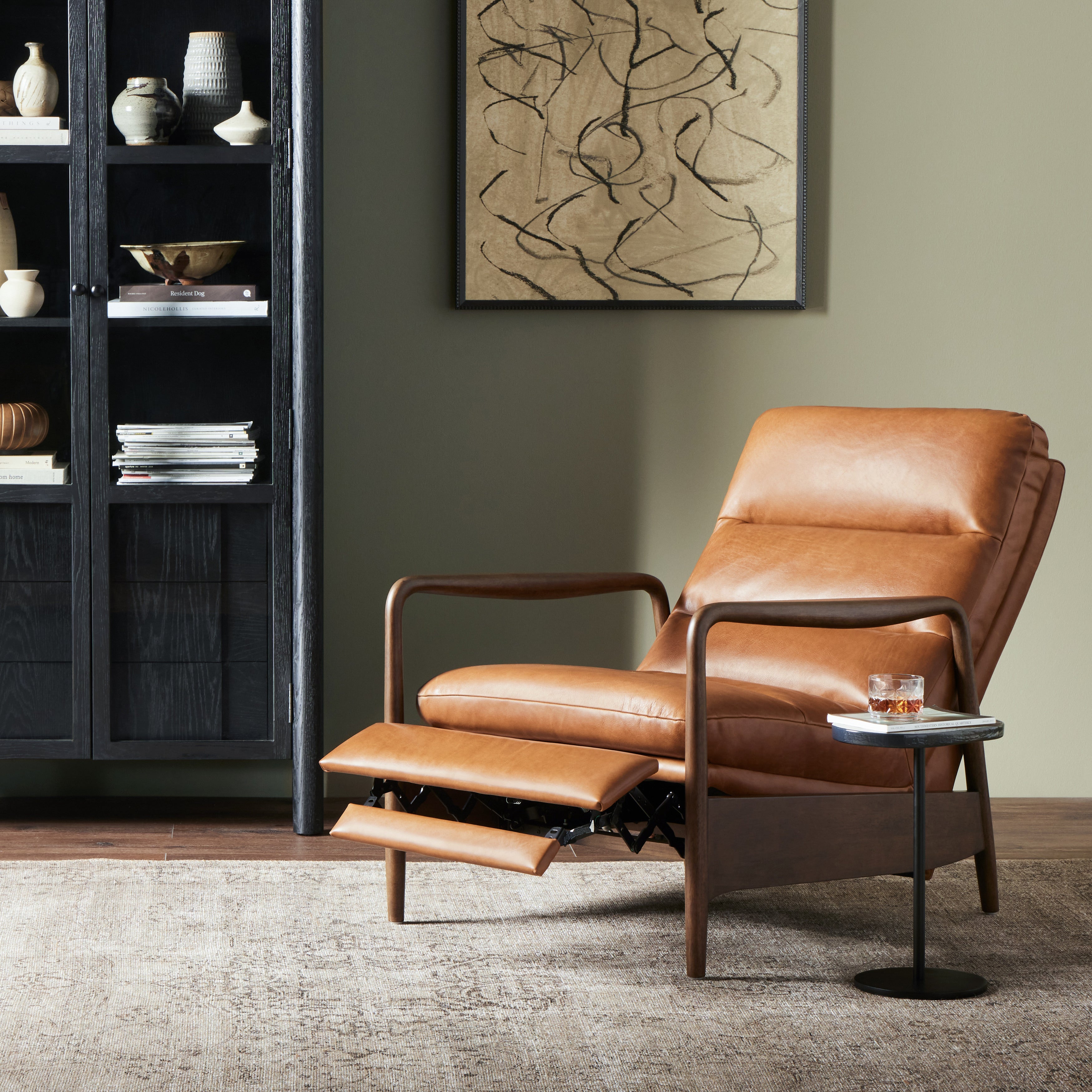 A sleek seat with hidden push-back reclining functionality. This midcentury-inspired recliner features wide chunky channeling paired with slim paddle arms and a tapered wood frame. Designed with a high seat and high back for extra comfy support. Upholstered in a timeless tobacco-hued leather made in a family-owned tannery in Thailand. Amethyst Home provides interior design, new construction, custom furniture, and area rugs in the San Diego metro area.