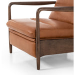 A sleek seat with hidden push-back reclining functionality. This midcentury-inspired recliner features wide chunky channeling paired with slim paddle arms and a tapered wood frame. Designed with a high seat and high back for extra comfy support. Upholstered in a timeless tobacco-hued leather made in a family-owned tannery in Thailand. Amethyst Home provides interior design, new construction, custom furniture, and area rugs in the Washington metro area.