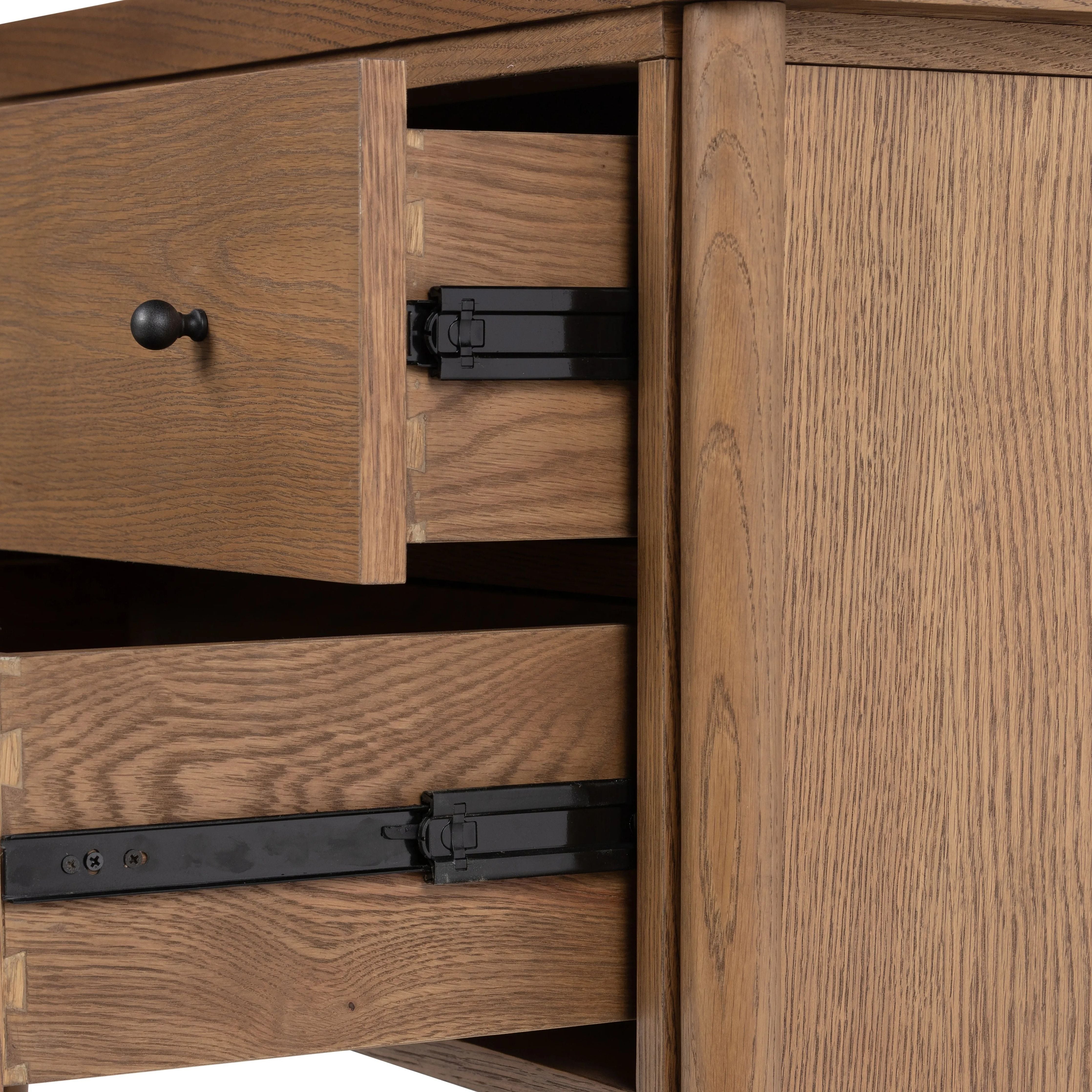 Rounded, chunky dowel legs in an amber oak finish support the overhang top of of this nightstand. Two drawers provide ample storage, finished with simple gunmetal hardware Amethyst Home provides interior design, new home construction design consulting, vintage area rugs, and lighting in the Calabasas metro area.