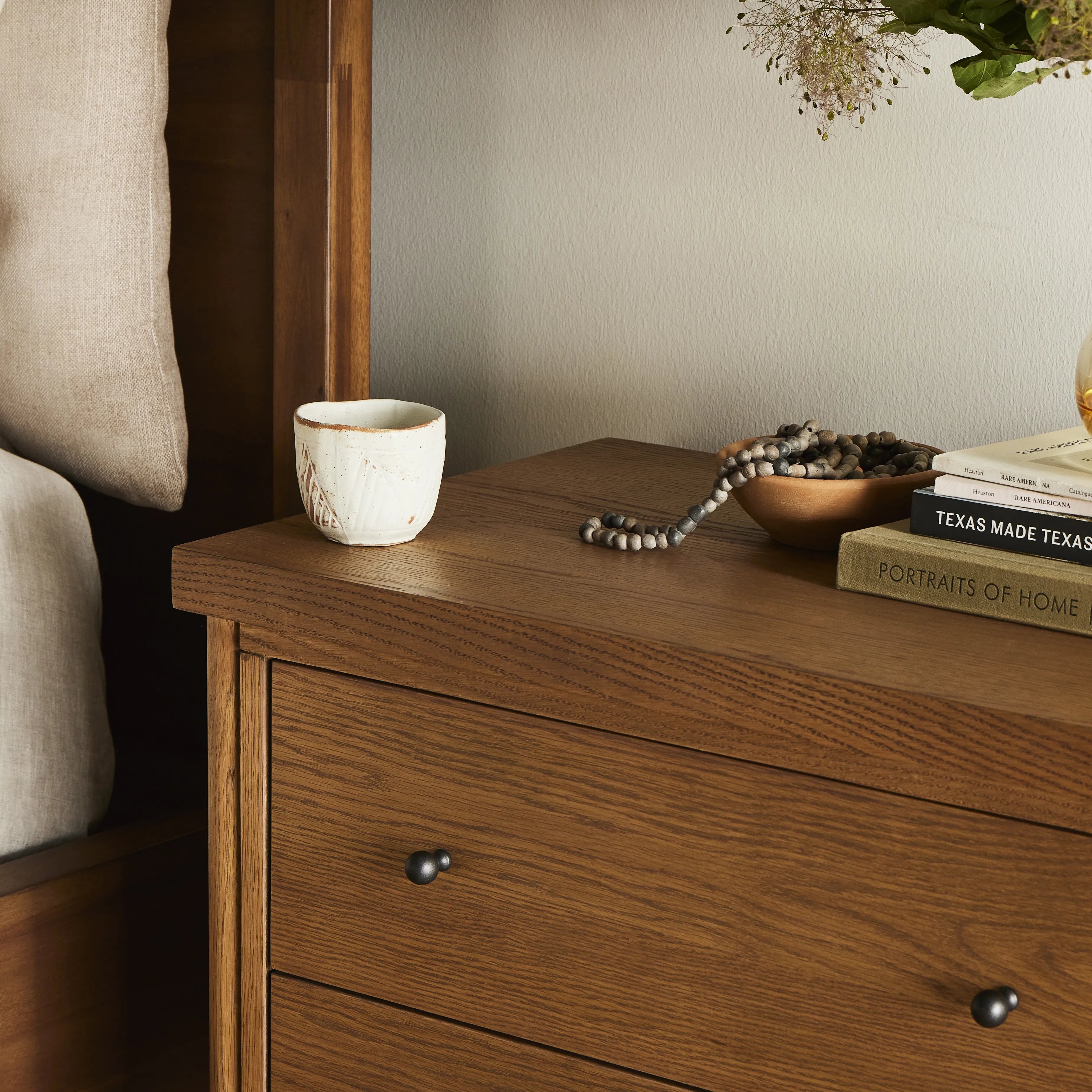 Rounded, chunky dowel legs in an amber oak finish support the overhang top of of this nightstand. Two drawers provide ample storage, finished with simple gunmetal hardware Amethyst Home provides interior design, new home construction design consulting, vintage area rugs, and lighting in the Nashville metro area.